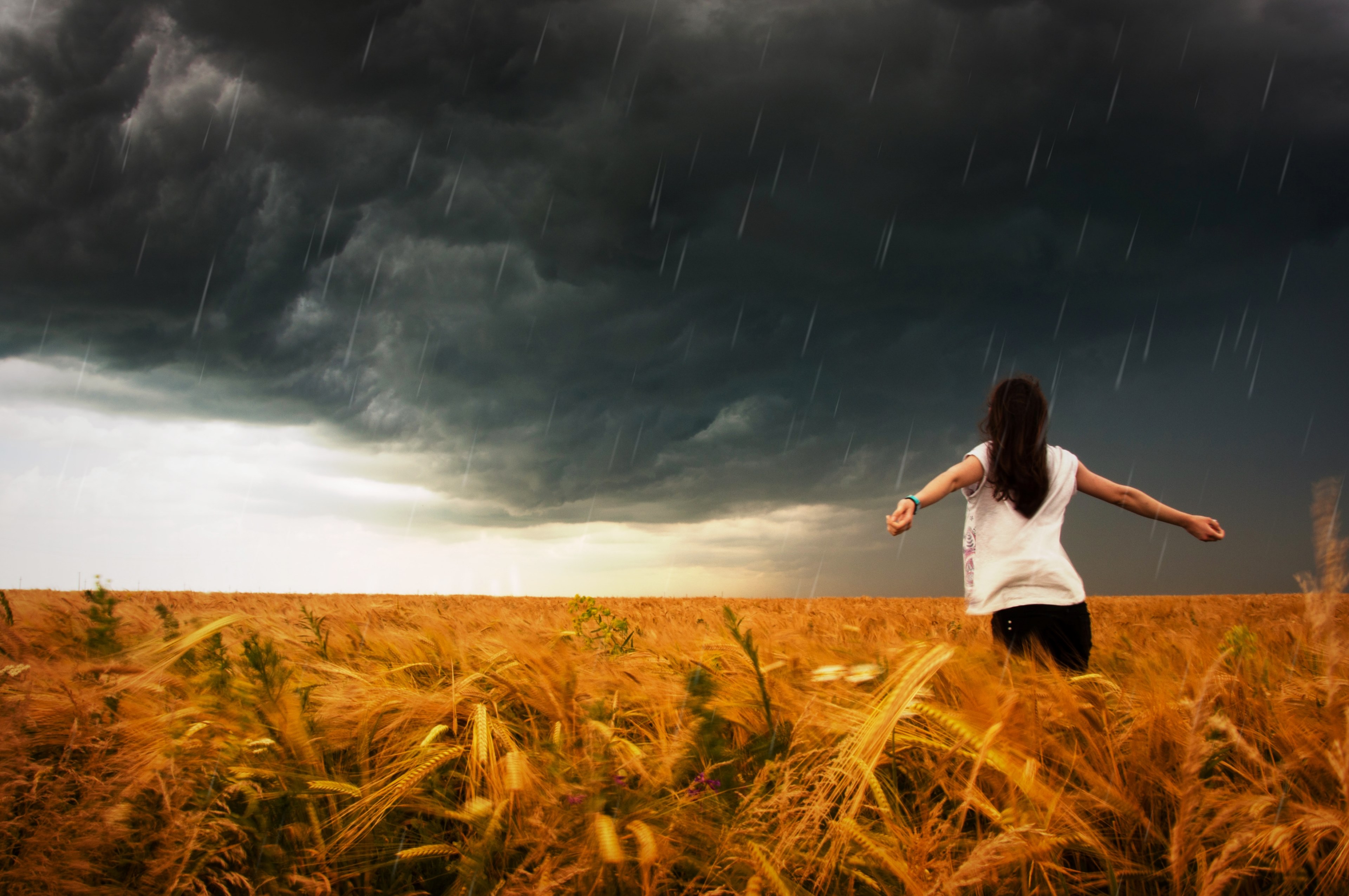 a woman holding her arms out and embracing the incoming storm, _woman standing in storm 4k, HD Wallpaper