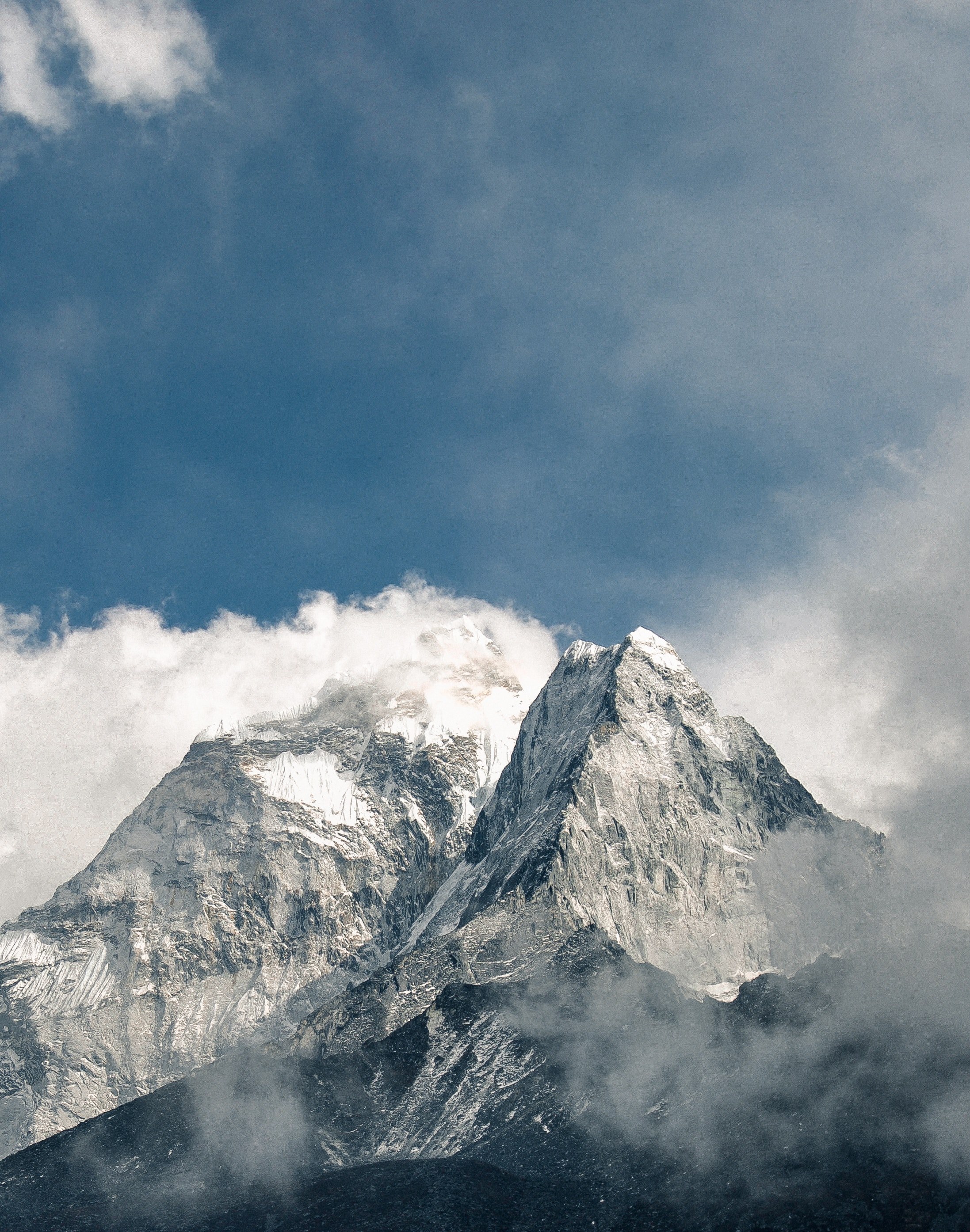 two mountain peaks cut through clouds towards a blue sky, years past 4k, Phone HD Wallpaper