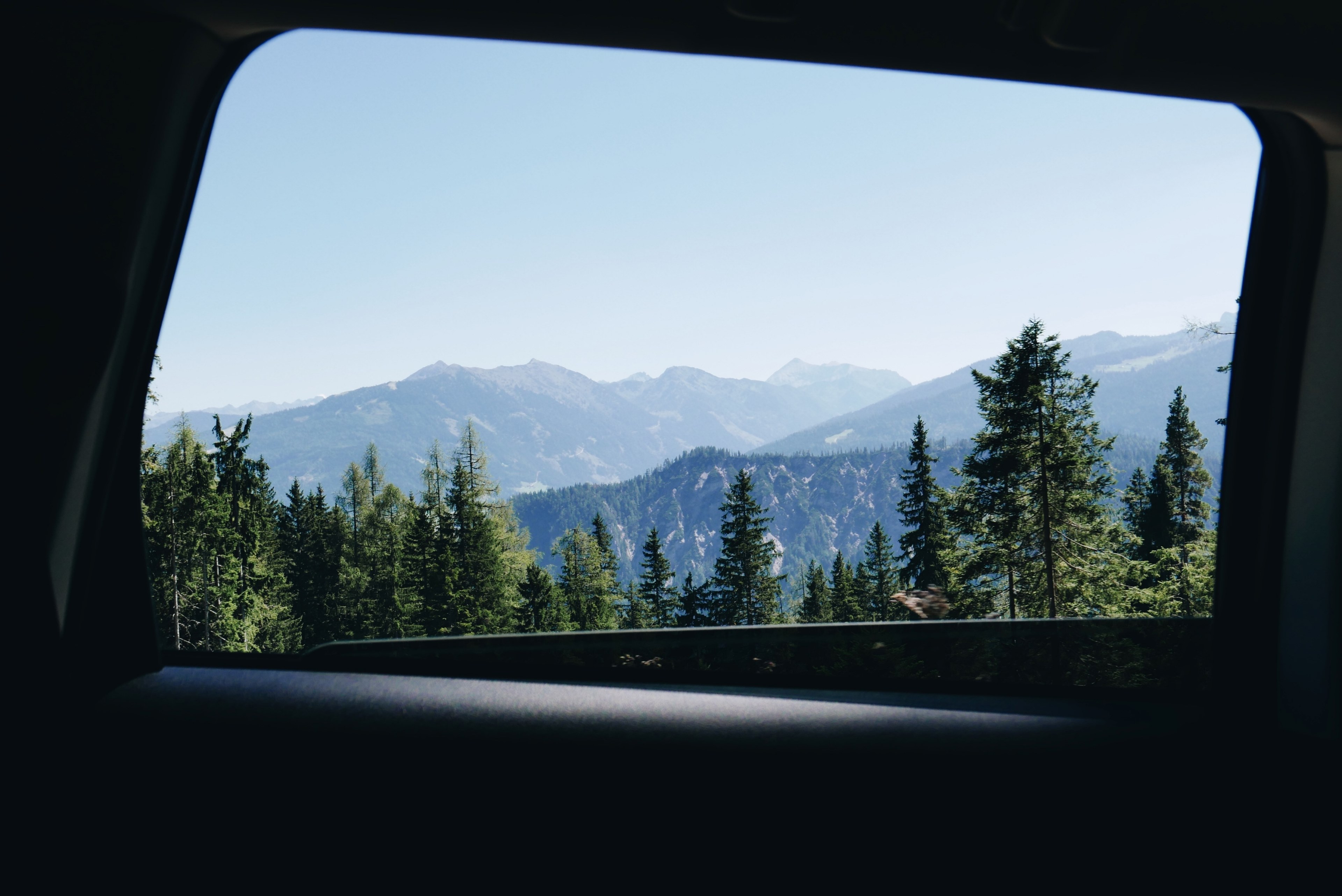 view from a car window on wooded slopes on a sunny day, road trip along the green mountains 4k, HD Wallpaper