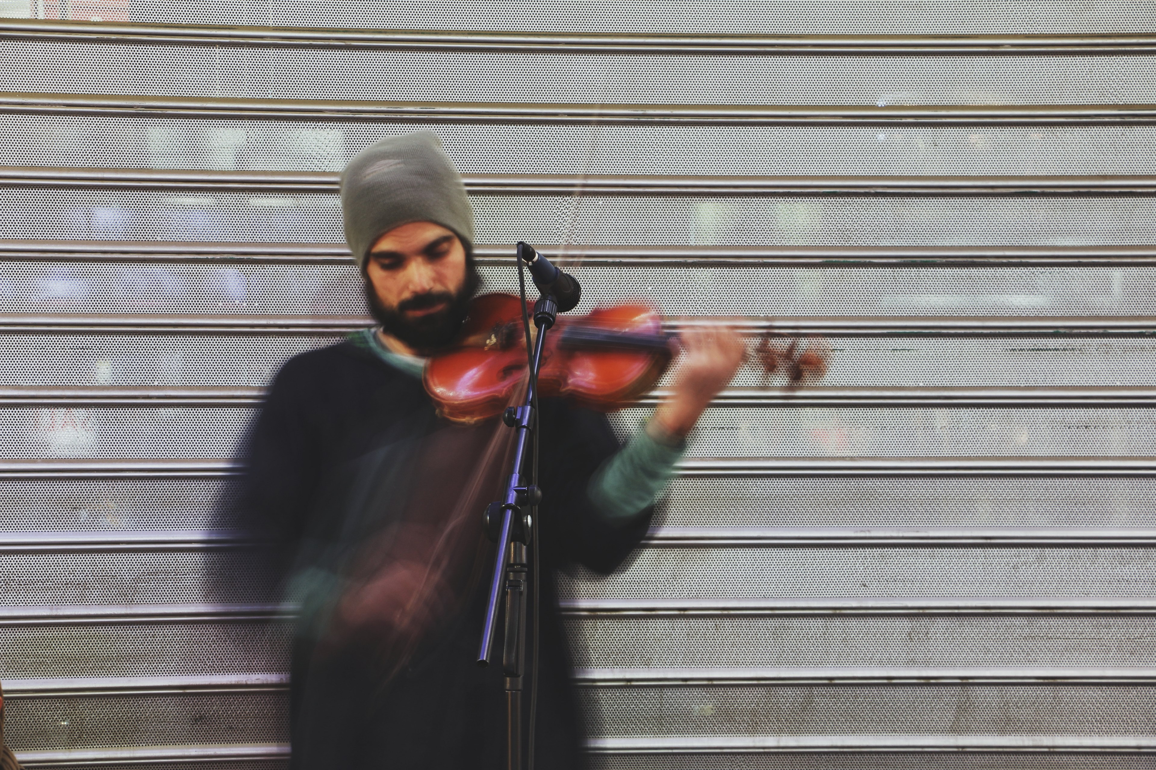 a bearded man in a beanie playing a violin next to a microphone in golestan shopping center, steady motions 4k, HD Wallpaper