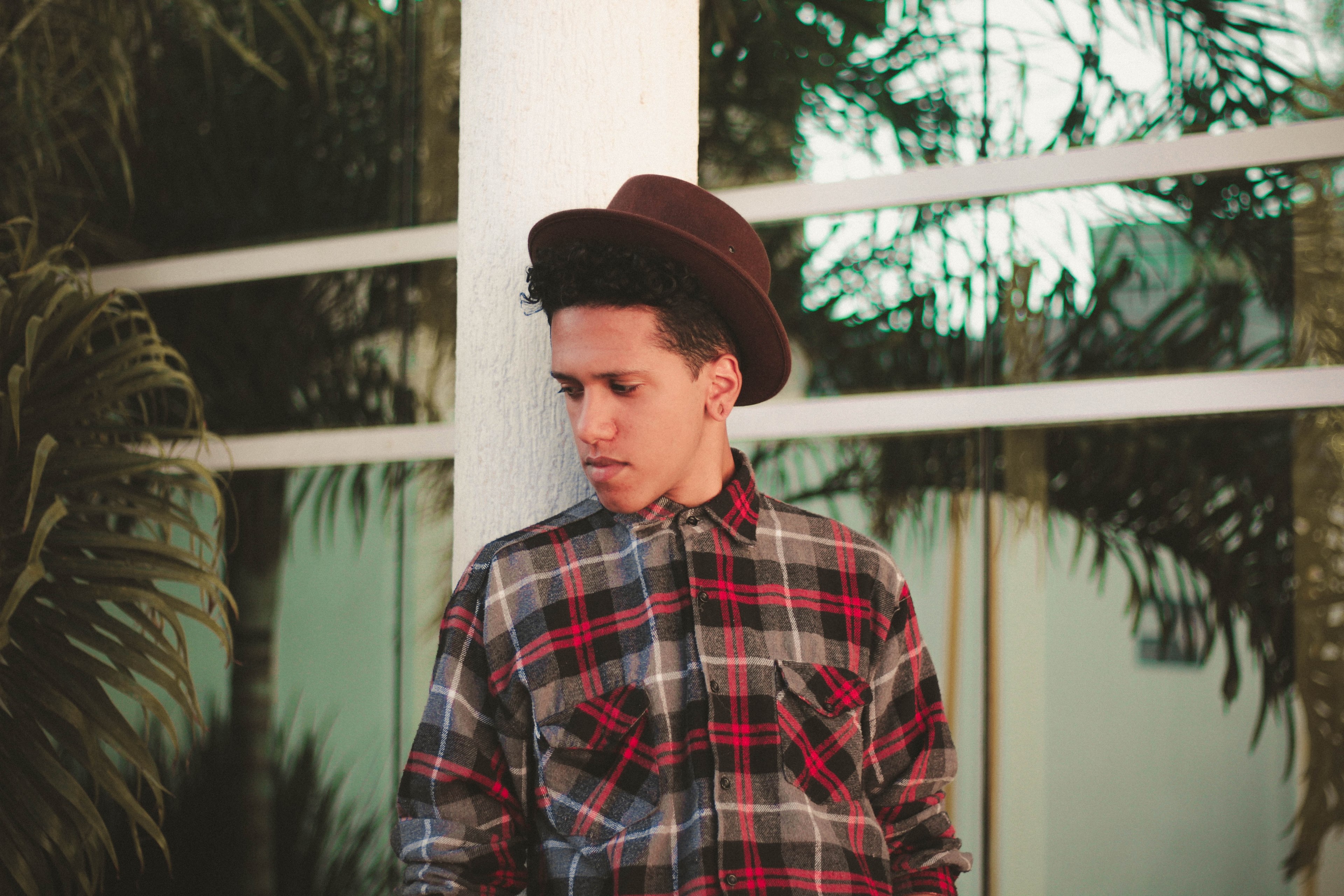 trendy man with a hat and plaid shirt leaning against a railing, posing in plaid 4k, HD Wallpaper