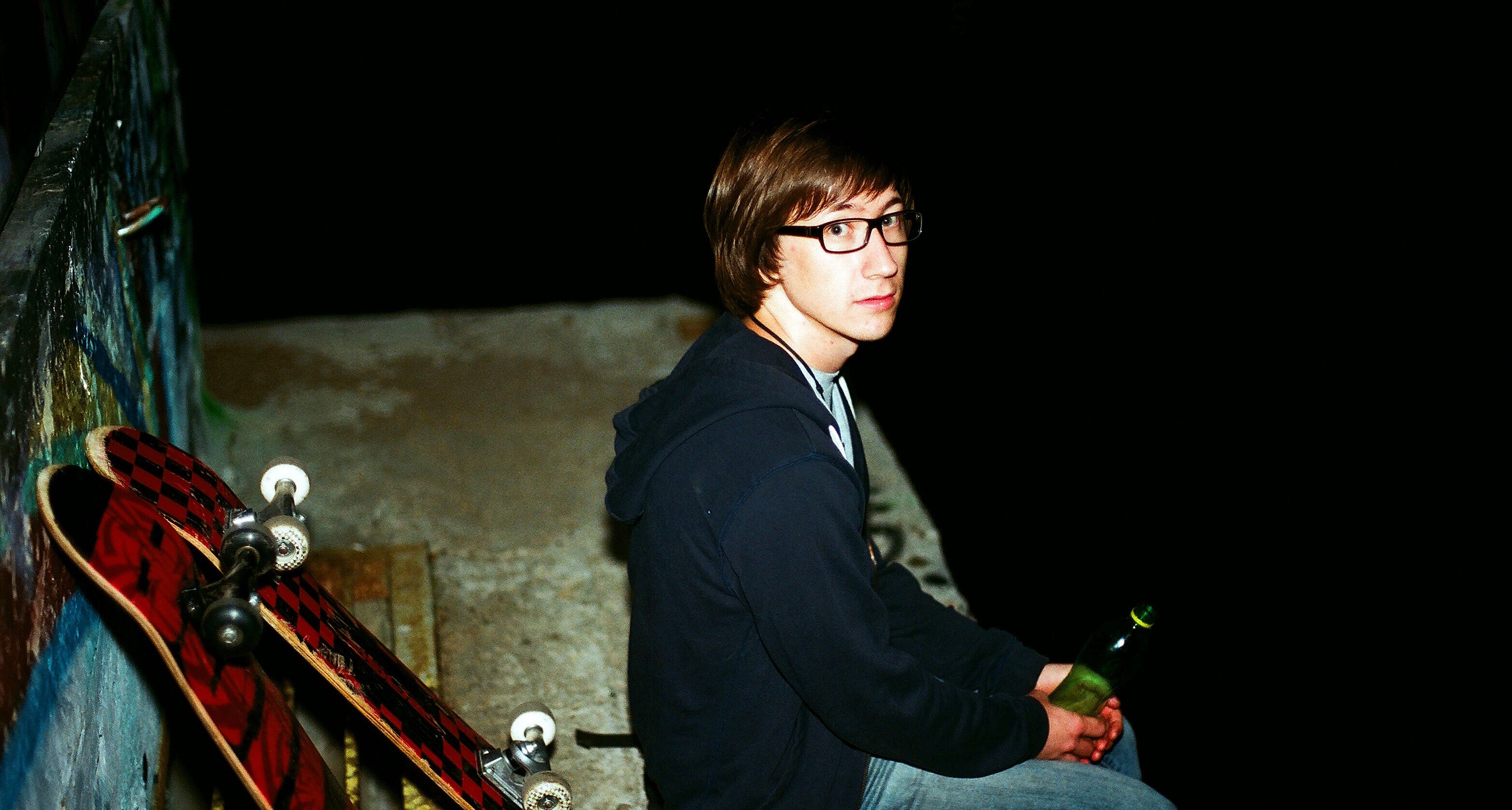 man holding a bottle sitting on a skate ramp by skateboards, skater boy 4k, HD Wallpaper