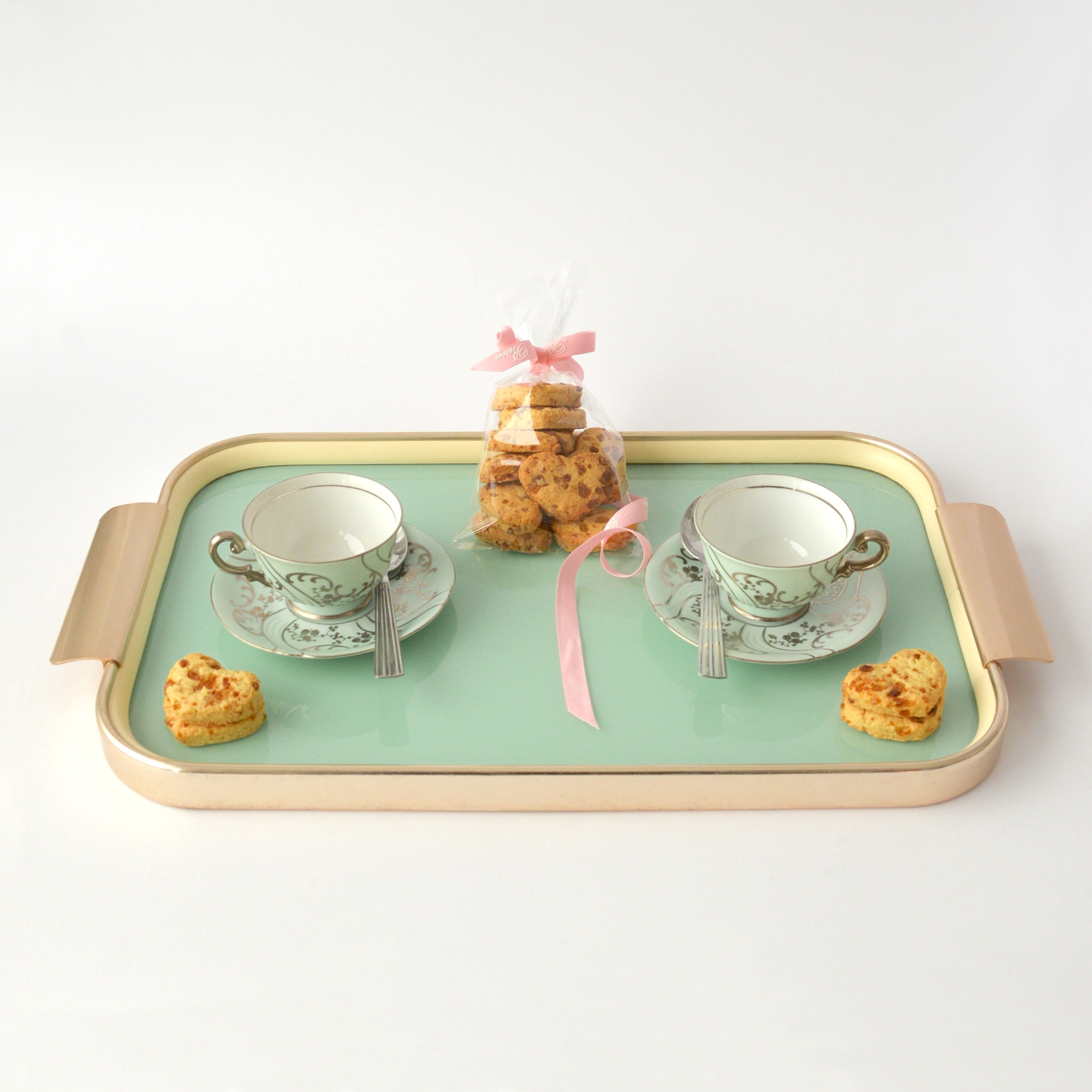 a tray with two teacups on saucers and a bag of cookies on a white surface, tray with teacups and cookies 4k, HD Wallpaper
