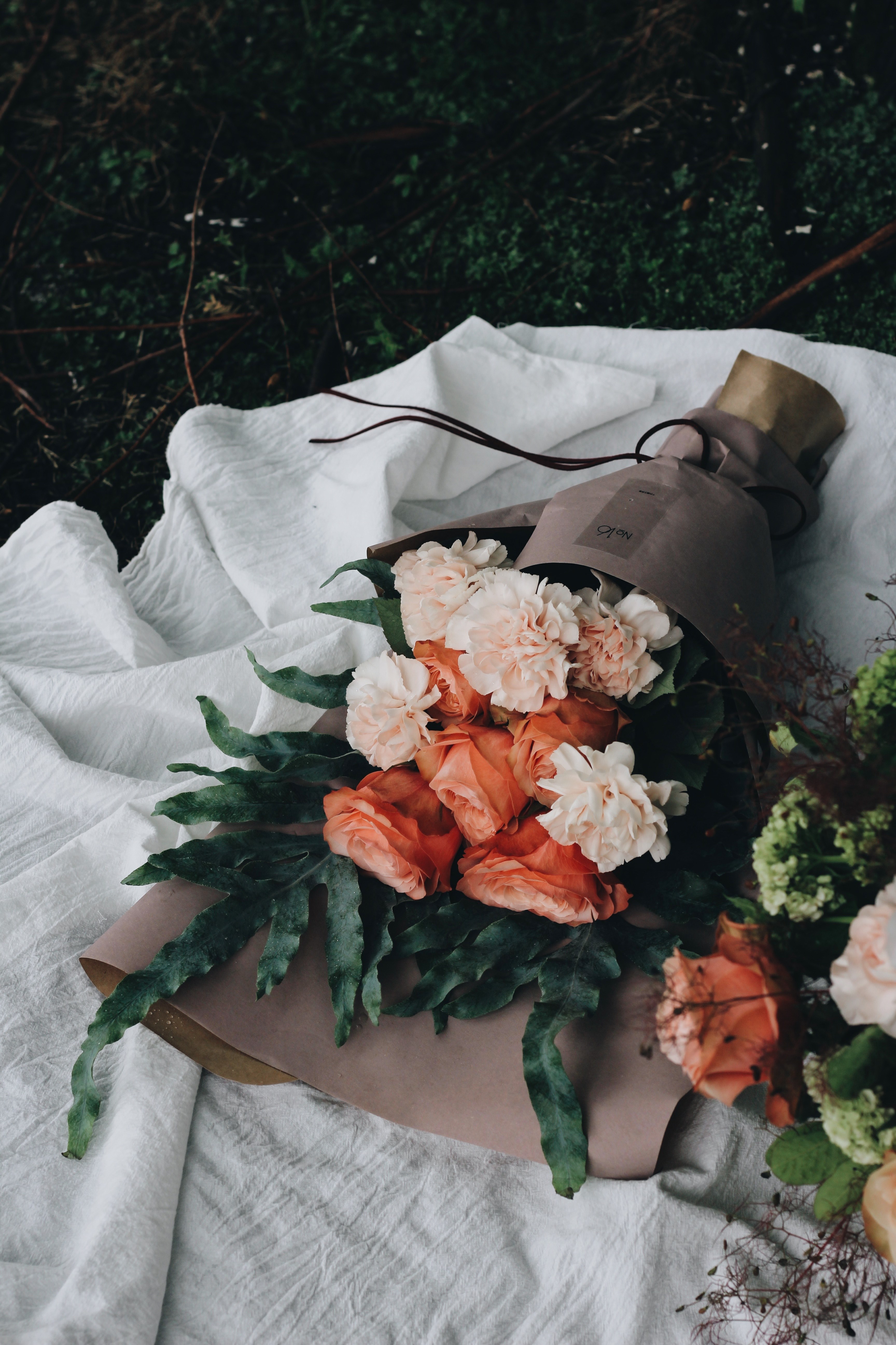large bouquets of pink carnations wrapped in paper and laid down on the ground, pink carnation bouquets 4k, Phone HD Wallpaper