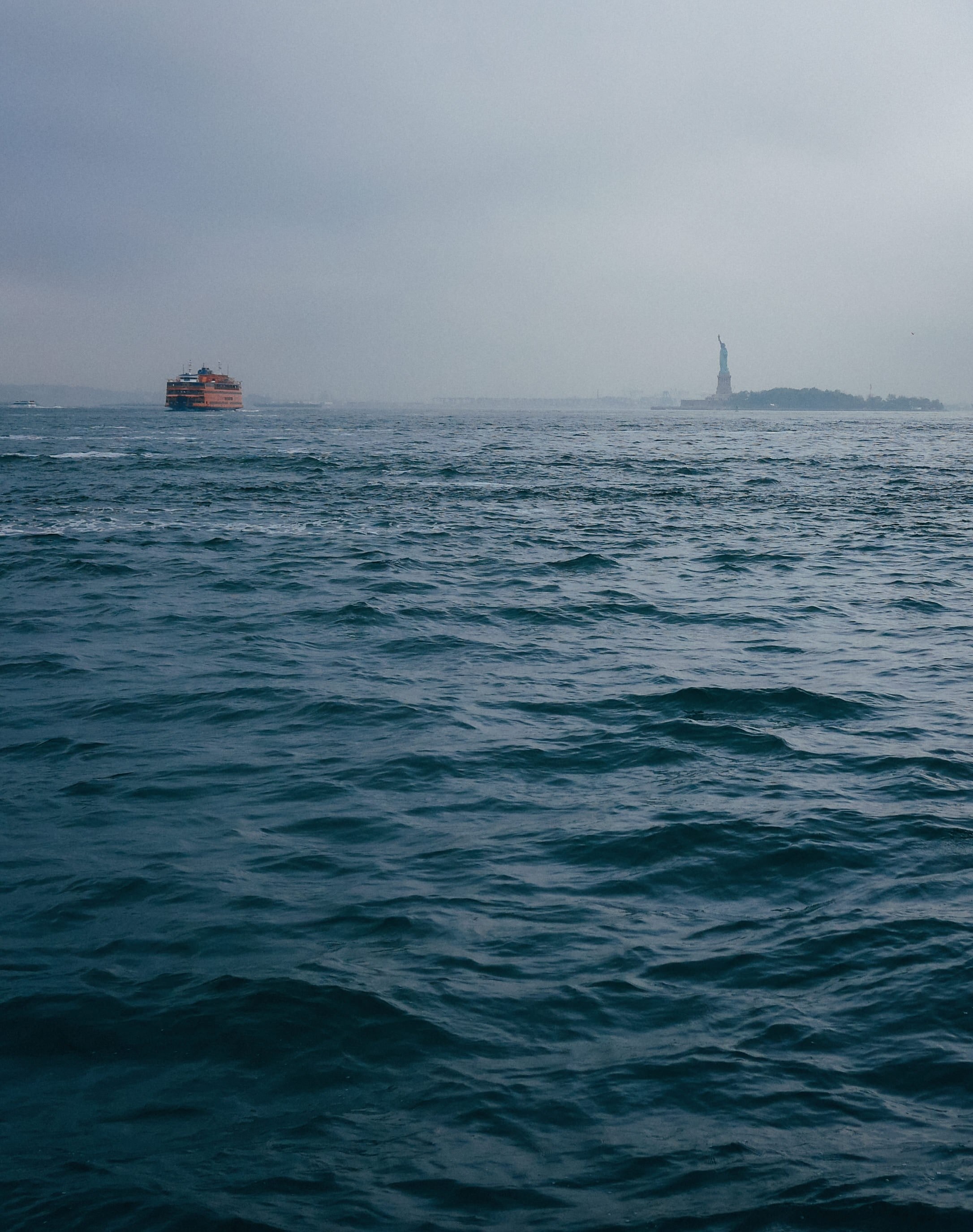 the statue of liberty and a cargo ship from the distance on a foggy day, the statue of liberty 4k, Phone HD Wallpaper