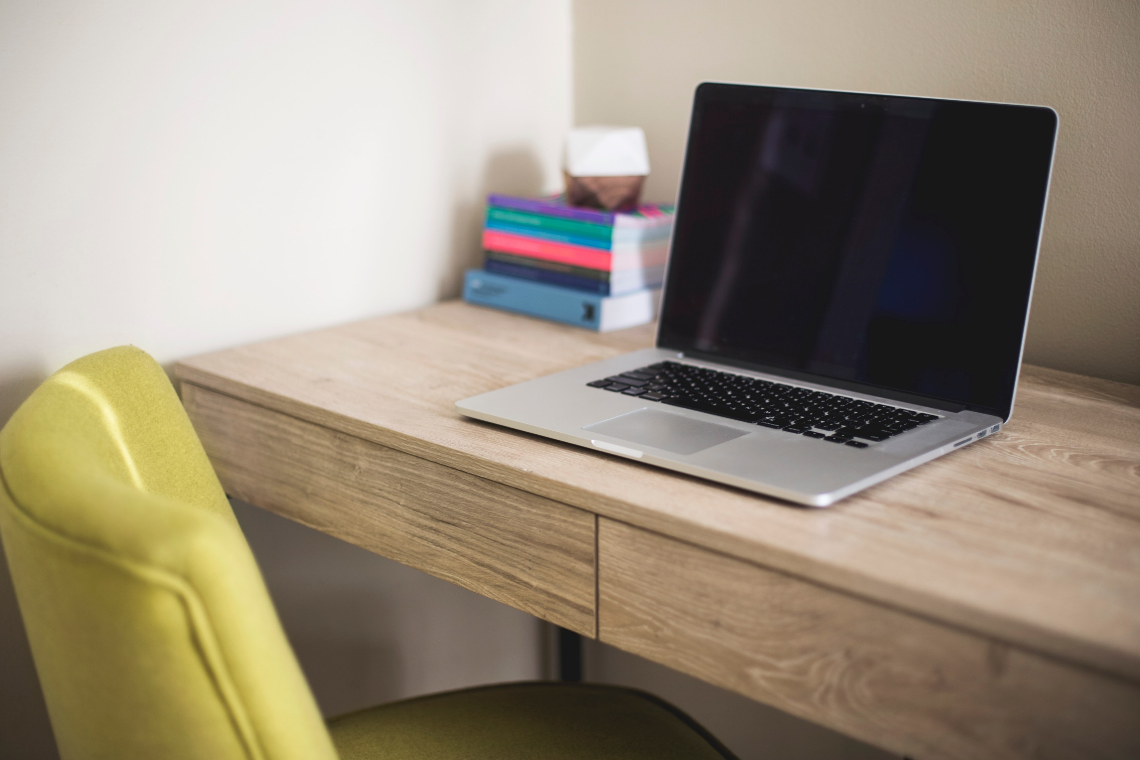 a macbook next to a stack of books on a wooden desk, laptop and books 4k, HD Wallpaper