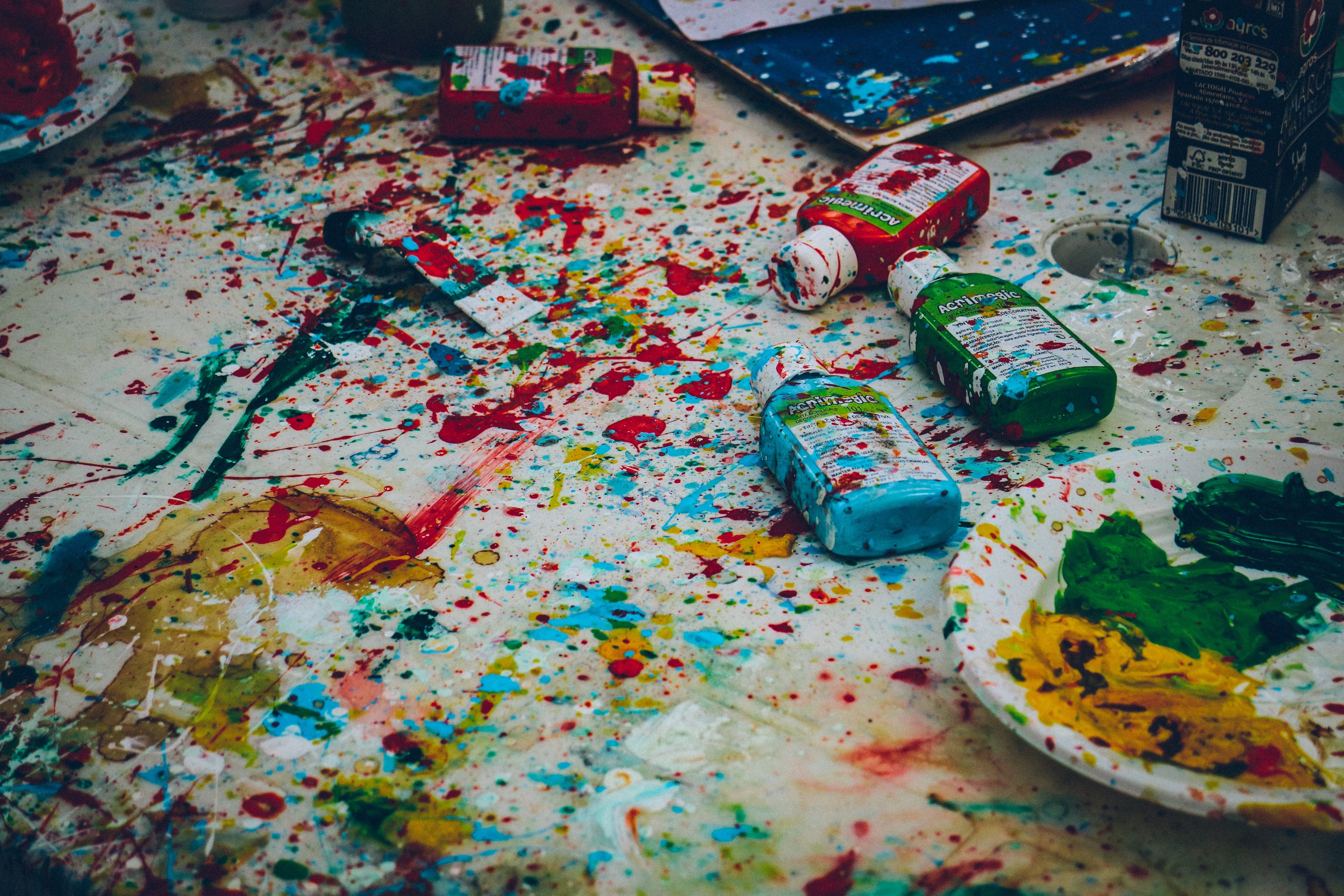 splattered colorful paint over a white table with bottles of paint in praia de santa cruz, splatter paint on white table 4k, HD Wallpaper