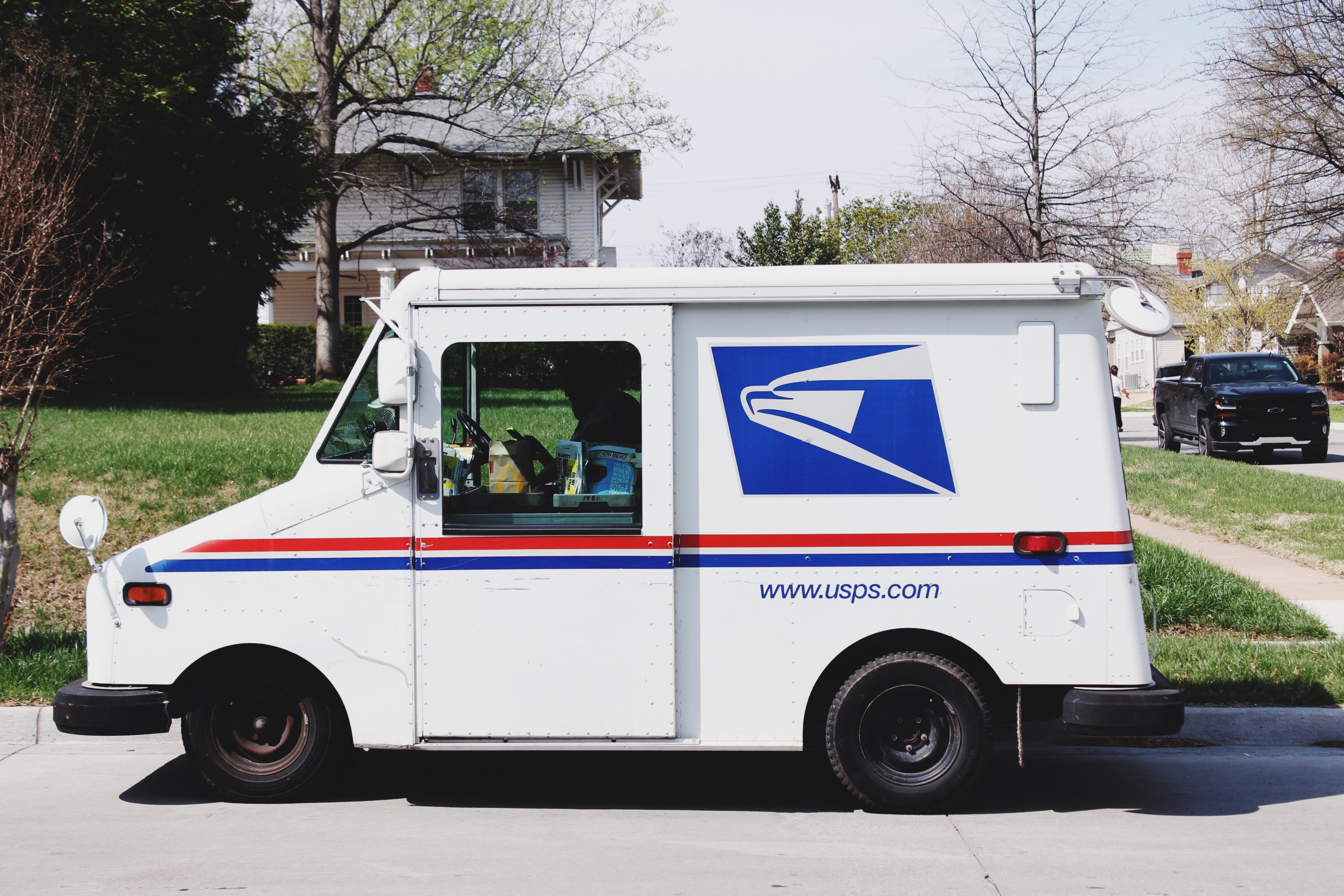 a mailman sitting in a mail truck sorting mail parked outside of a house in tulsa, mail time 4k, HD Wallpaper