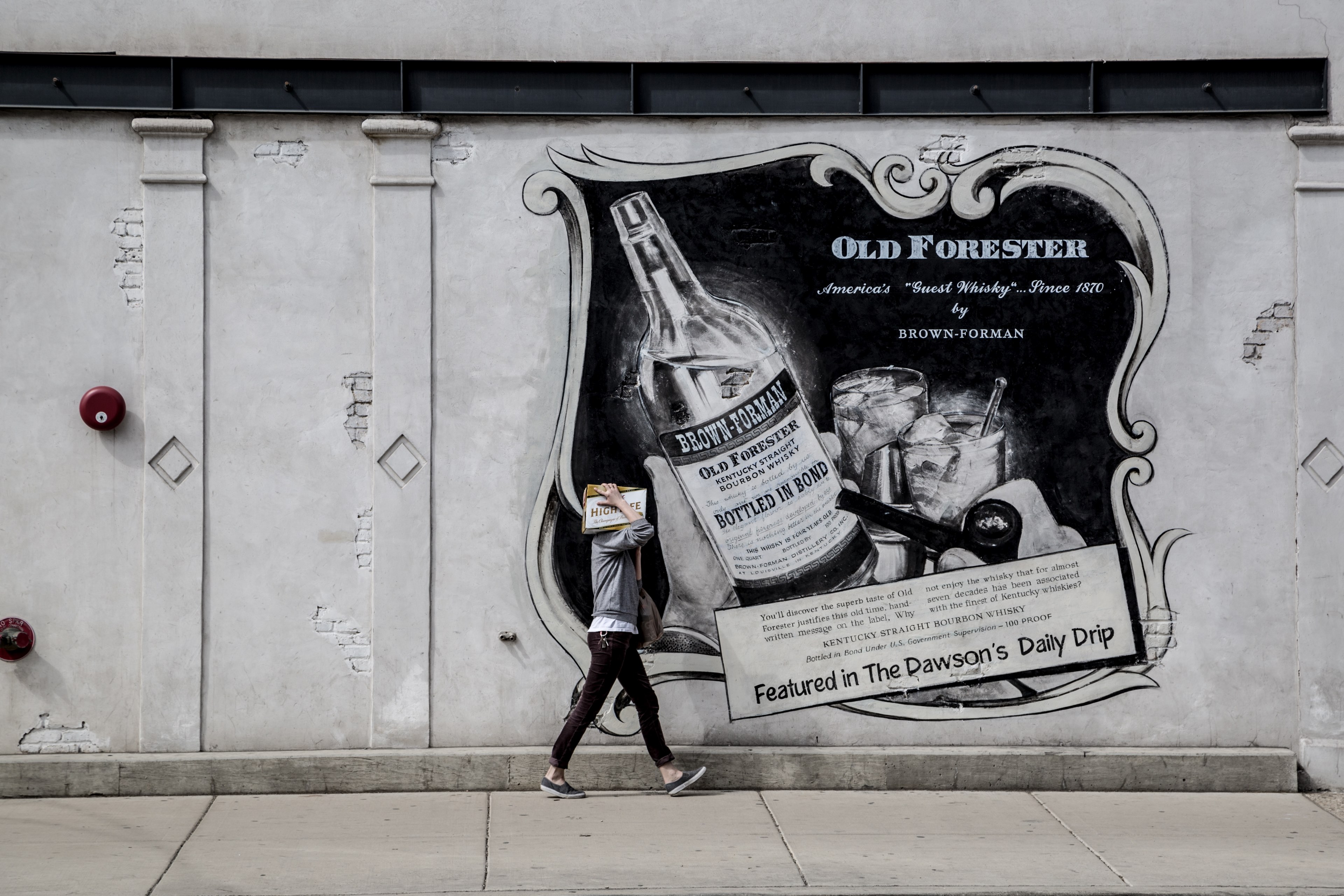a person walking by an advertisement poster in front of a building in central chicago illinois usa, a person walking by a poster 4k, HD Wallpaper