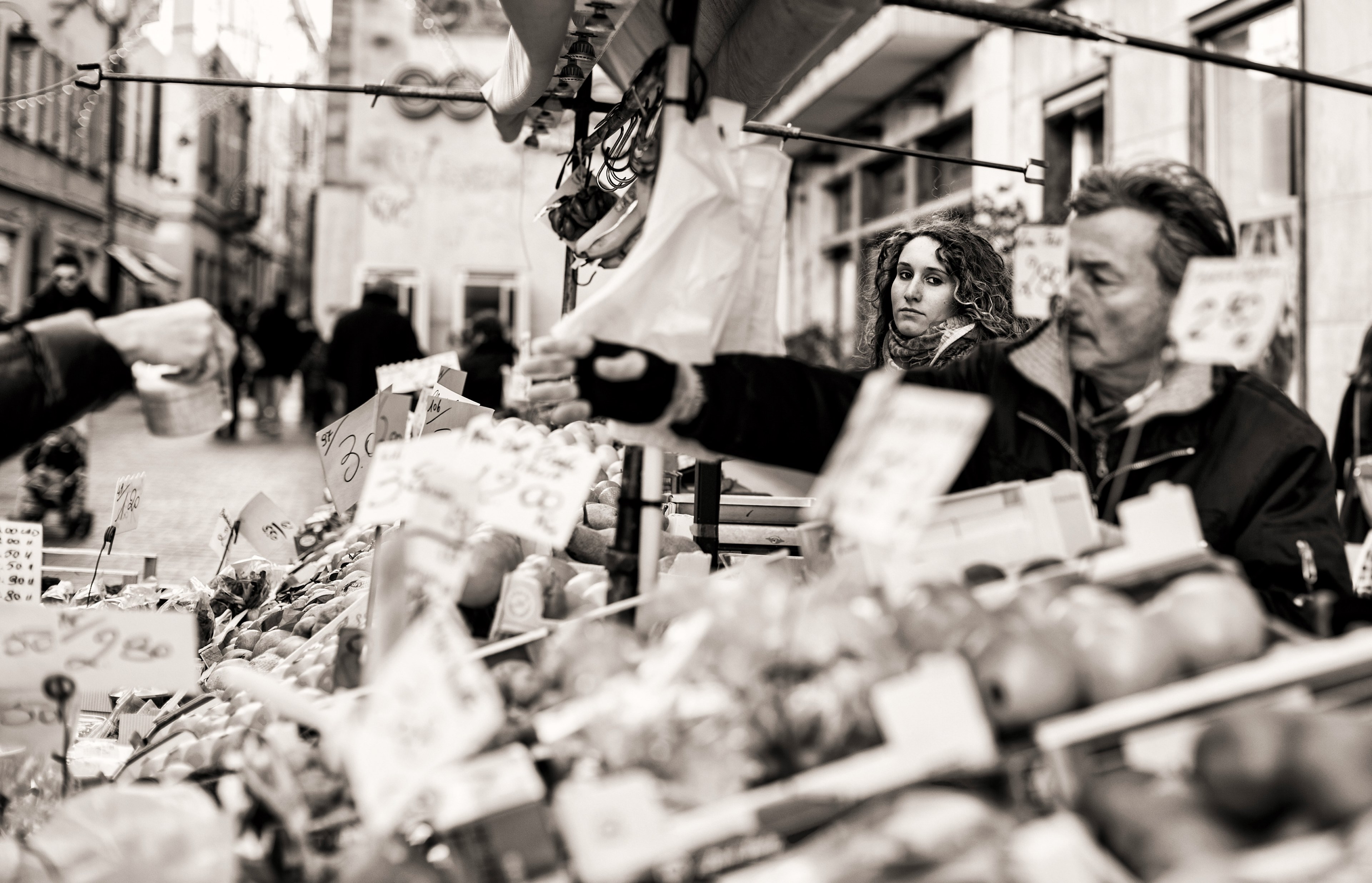 a black and white shot of people selecting produce at a market stall, the lady in the street 4k, HD Wallpaper