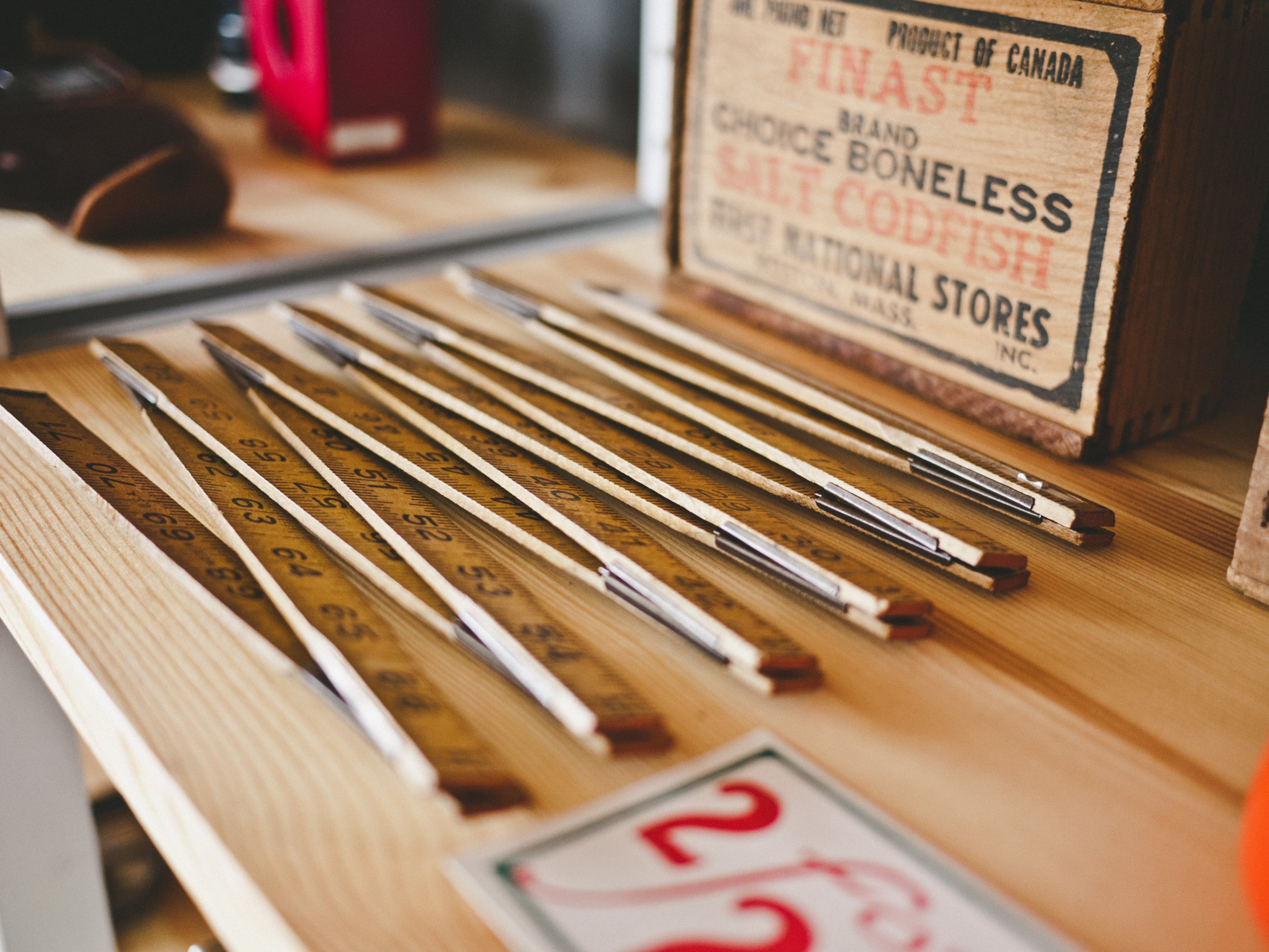 a folding ruler next to wooden boxes on a table, folding ruler and wooden boxes 4k, HD Wallpaper