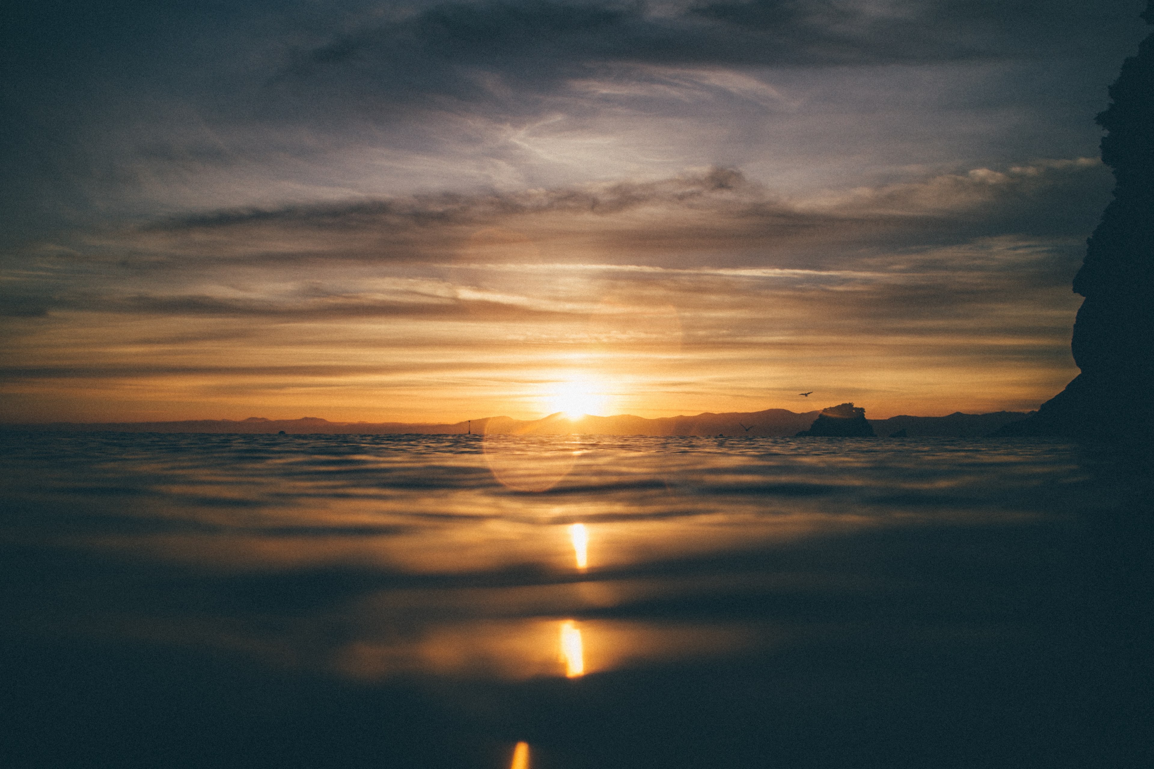 the water at a beach reflecting the orange and blue sky at sunset or sunrise in kaiteriteri, too early isnt too hard 4k, HD Wallpaper