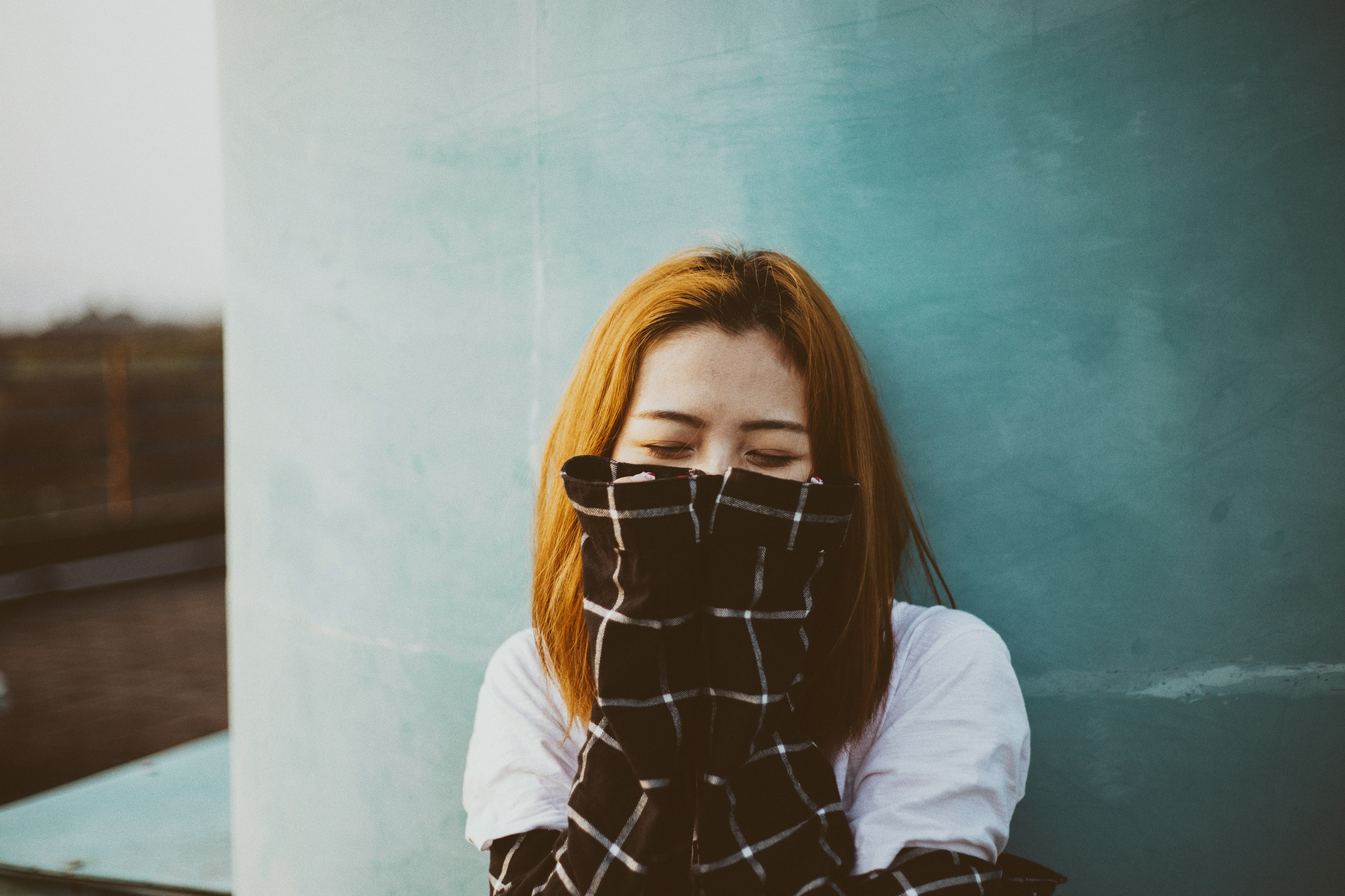a woman with red hair wearing a flannel shirt in pleiku, sleeves over her face 4k, HD Wallpaper