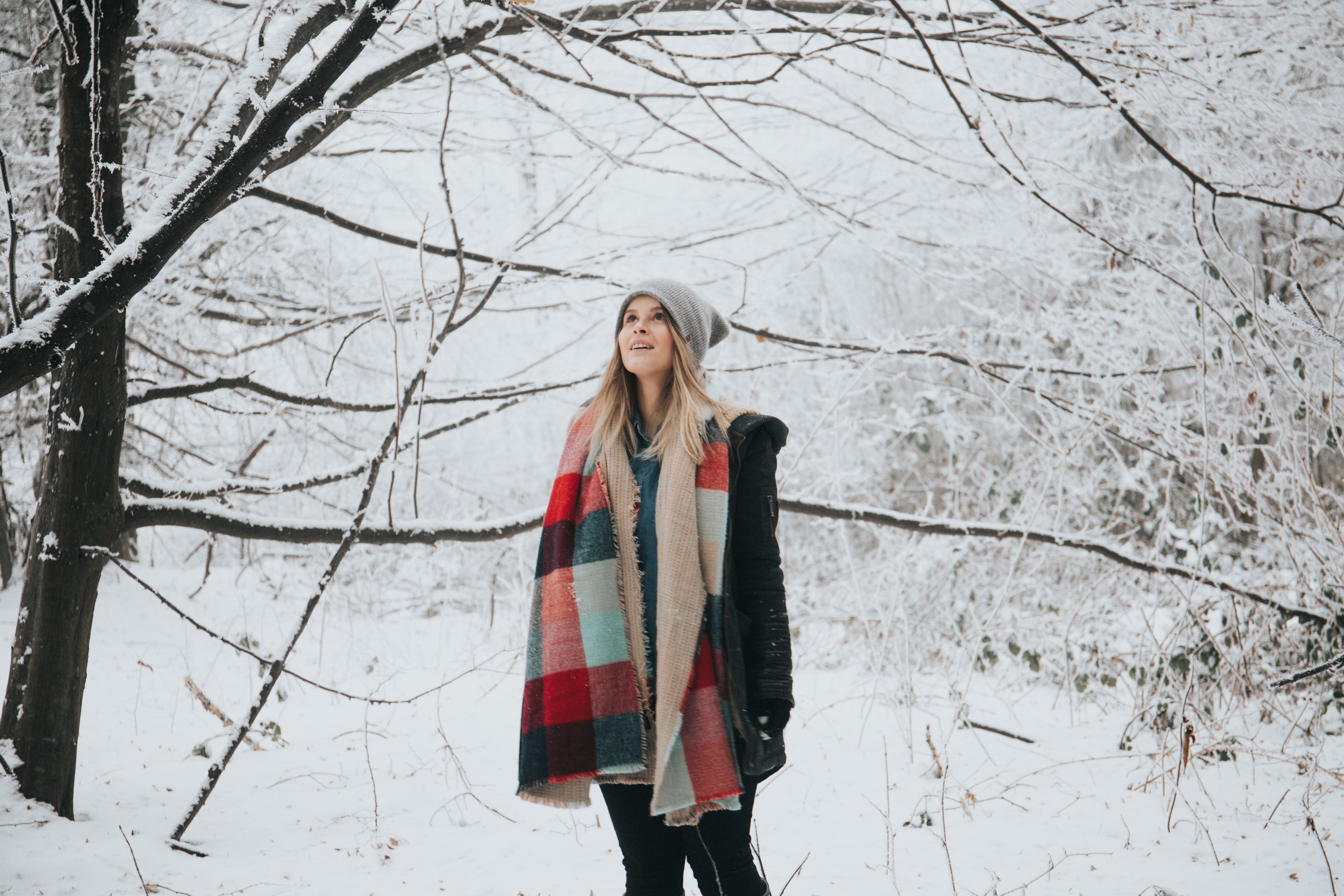 happy woman in a hat and scarf stares in awe at snowy trees, in a winter wonderland 4k, HD Wallpaper