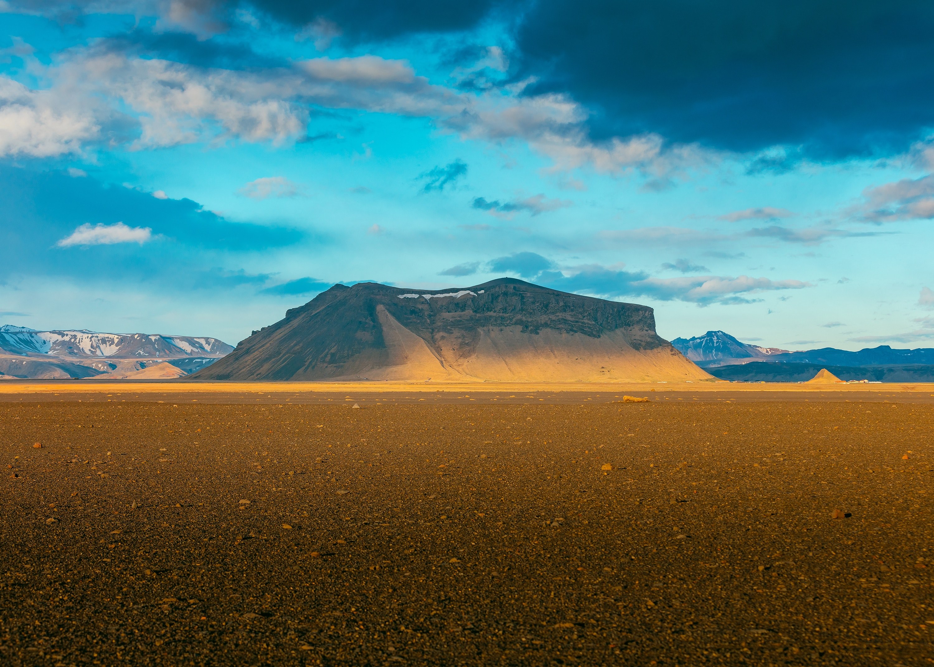 a rocky plain with a flat mountain at the back on a cloudy day, break in the clouds 4k, HD Wallpaper