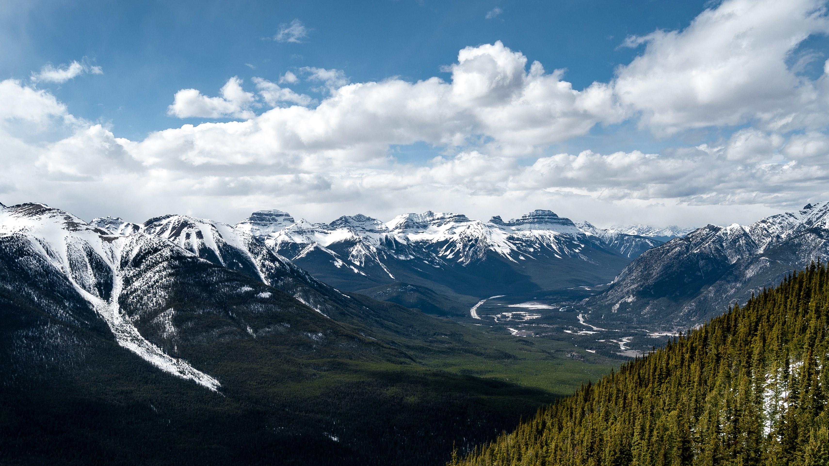 a picturesque green valley surrounded by snow capped mountains, green valley in the white mountains 4k, HD Wallpaper