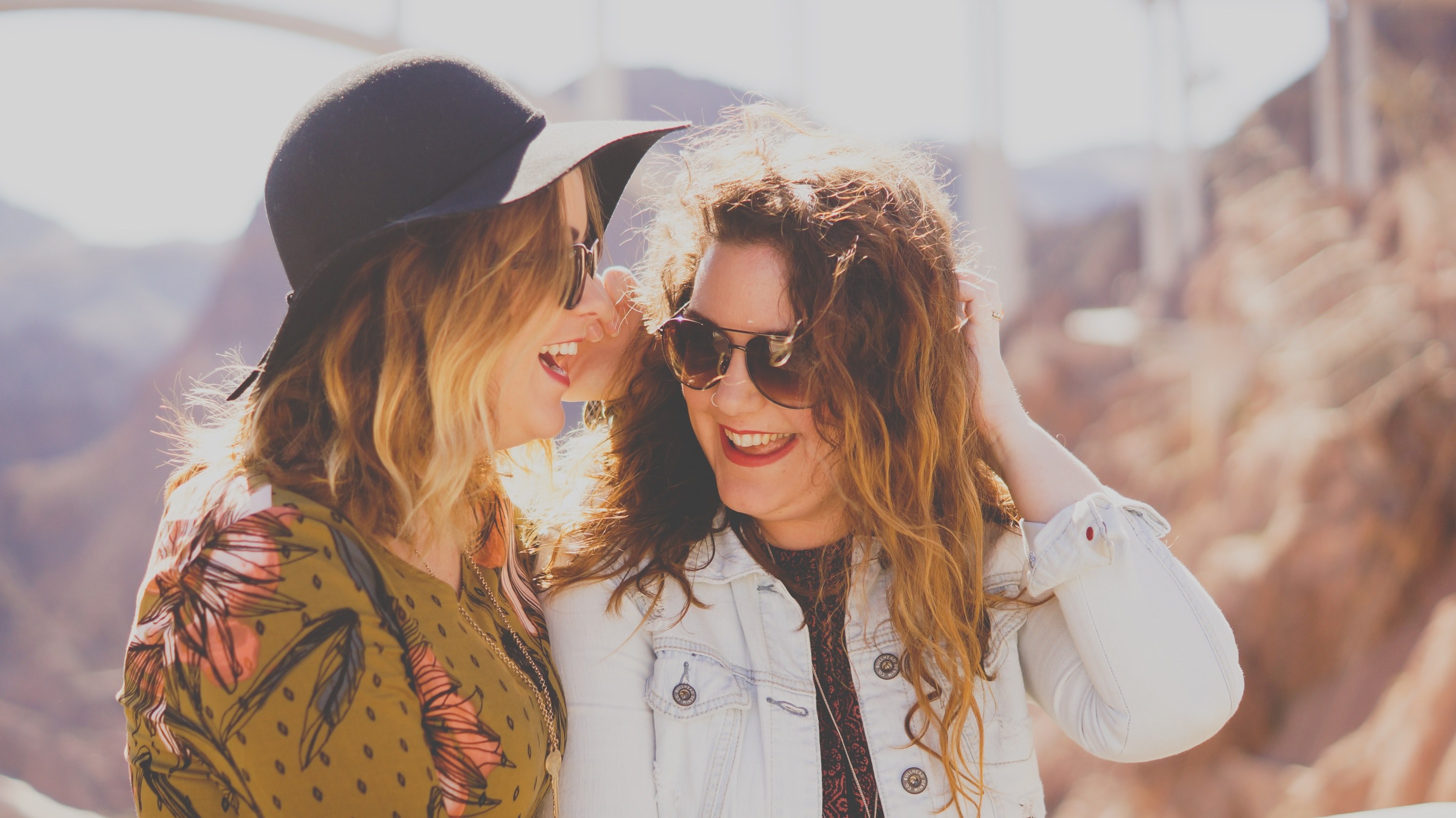 two fashionable women at the hoover dam access road stand closely laughing in the sunshine, photographer friends 4k, HD Wallpaper