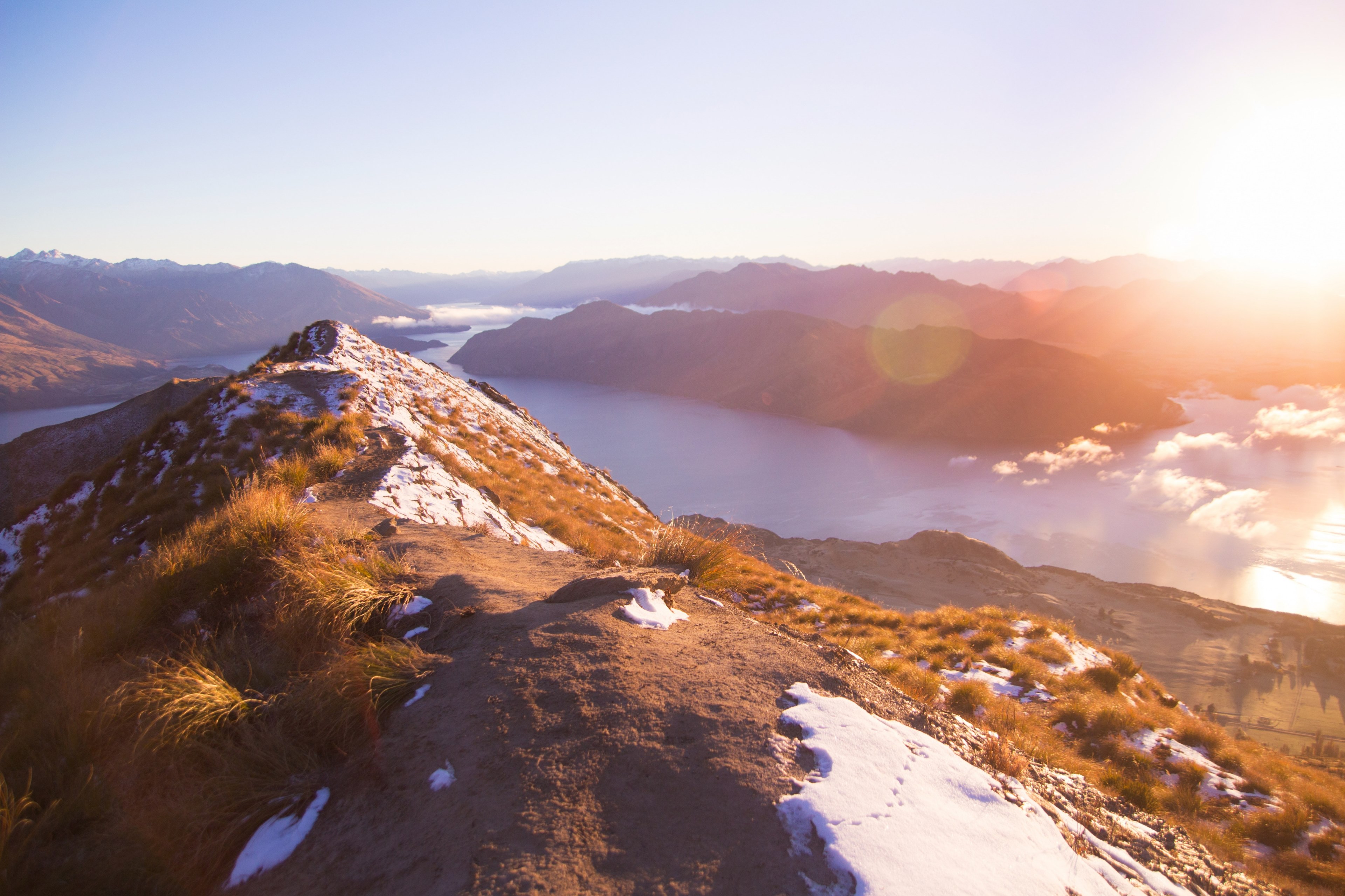view from a low mountain ridge on a snowy peak and a river below during sunset, sunrise at roys peak 4k, HD Wallpaper