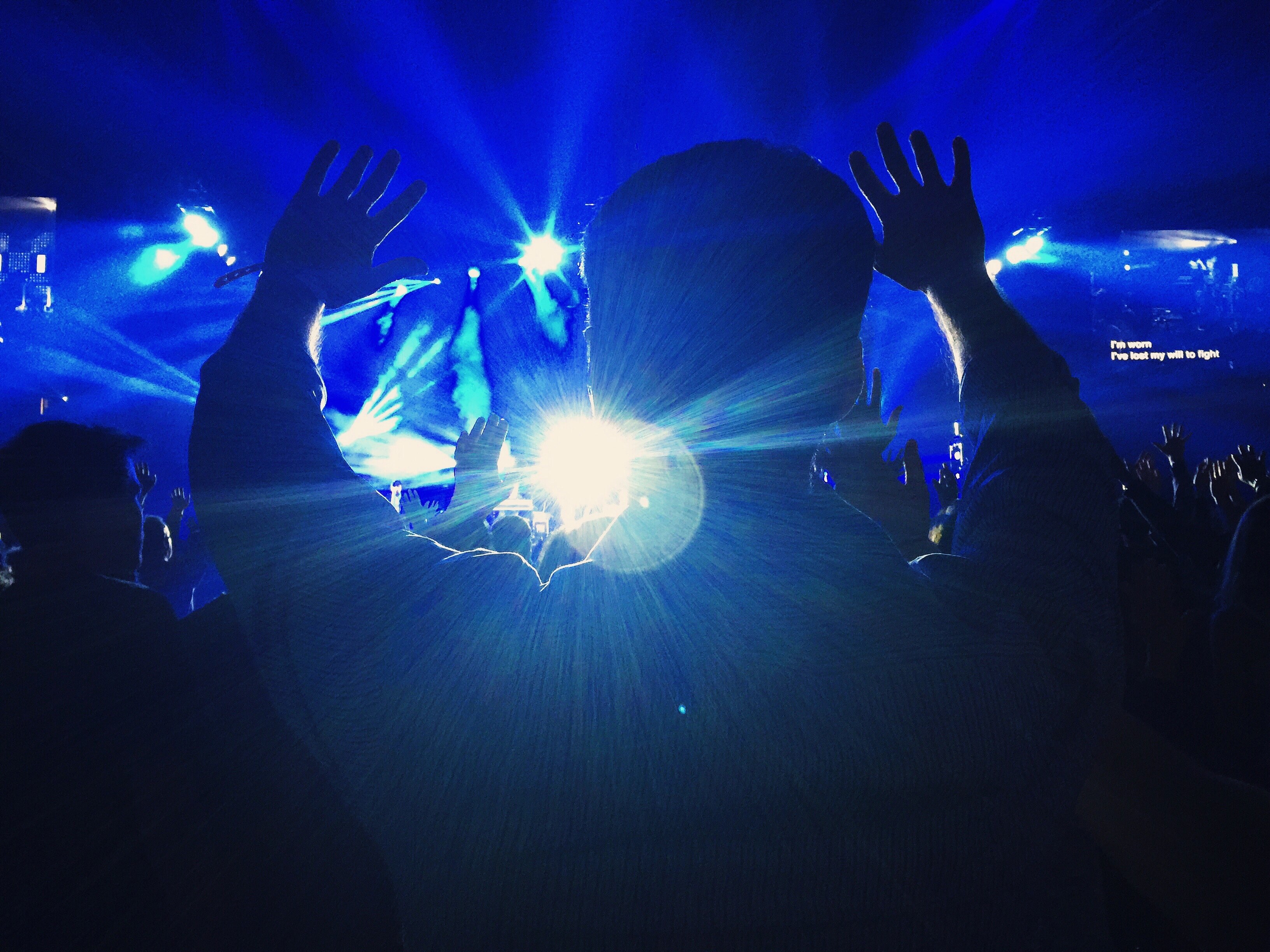 the silhouette of a person at a concert throwing their hands up in the blue light, enjoying the concert 4k, HD Wallpaper