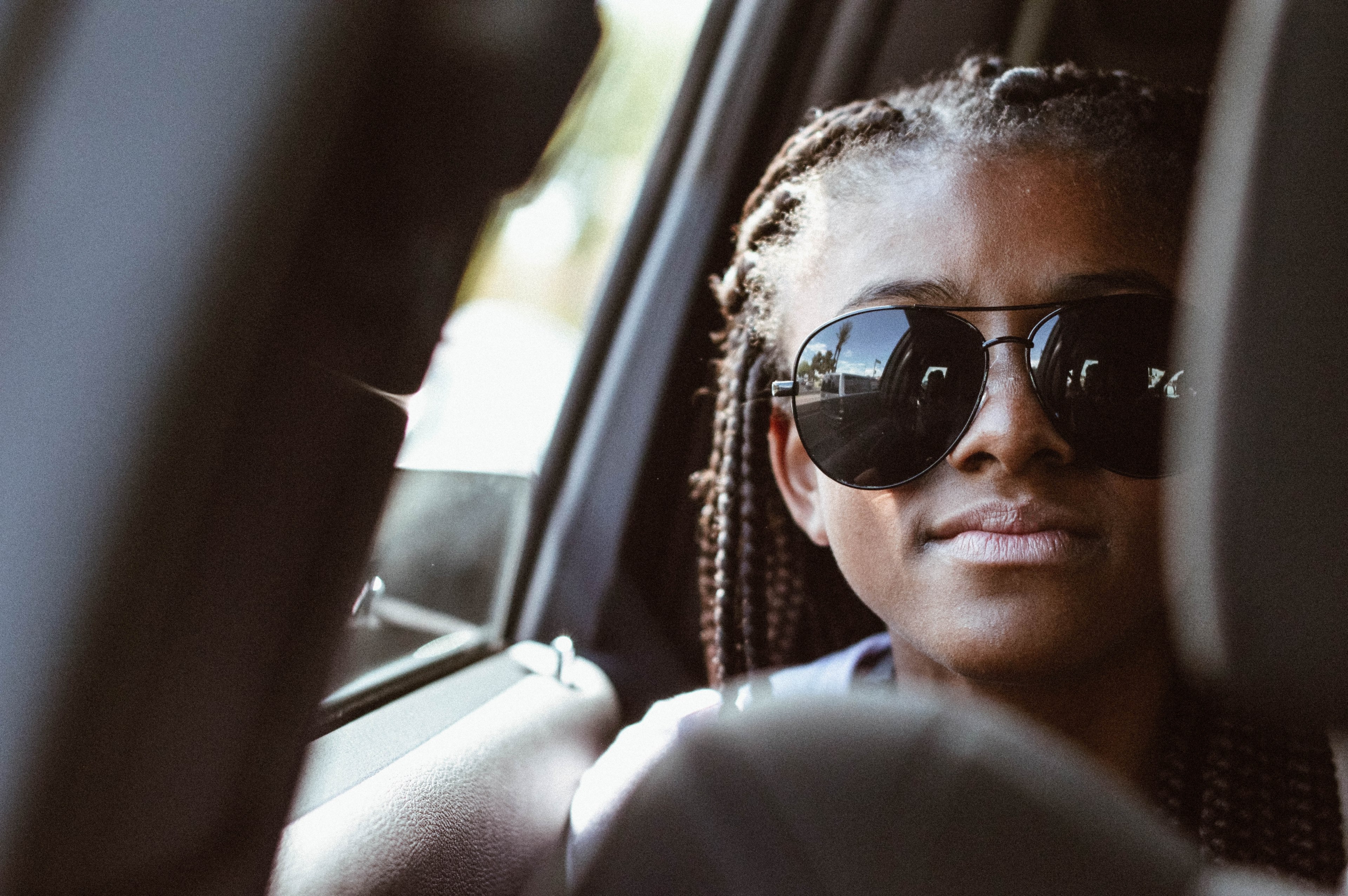 a woman in braids and sunglasses riding in a car pictured through the seats, woman riding in a car 4k, HD Wallpaper