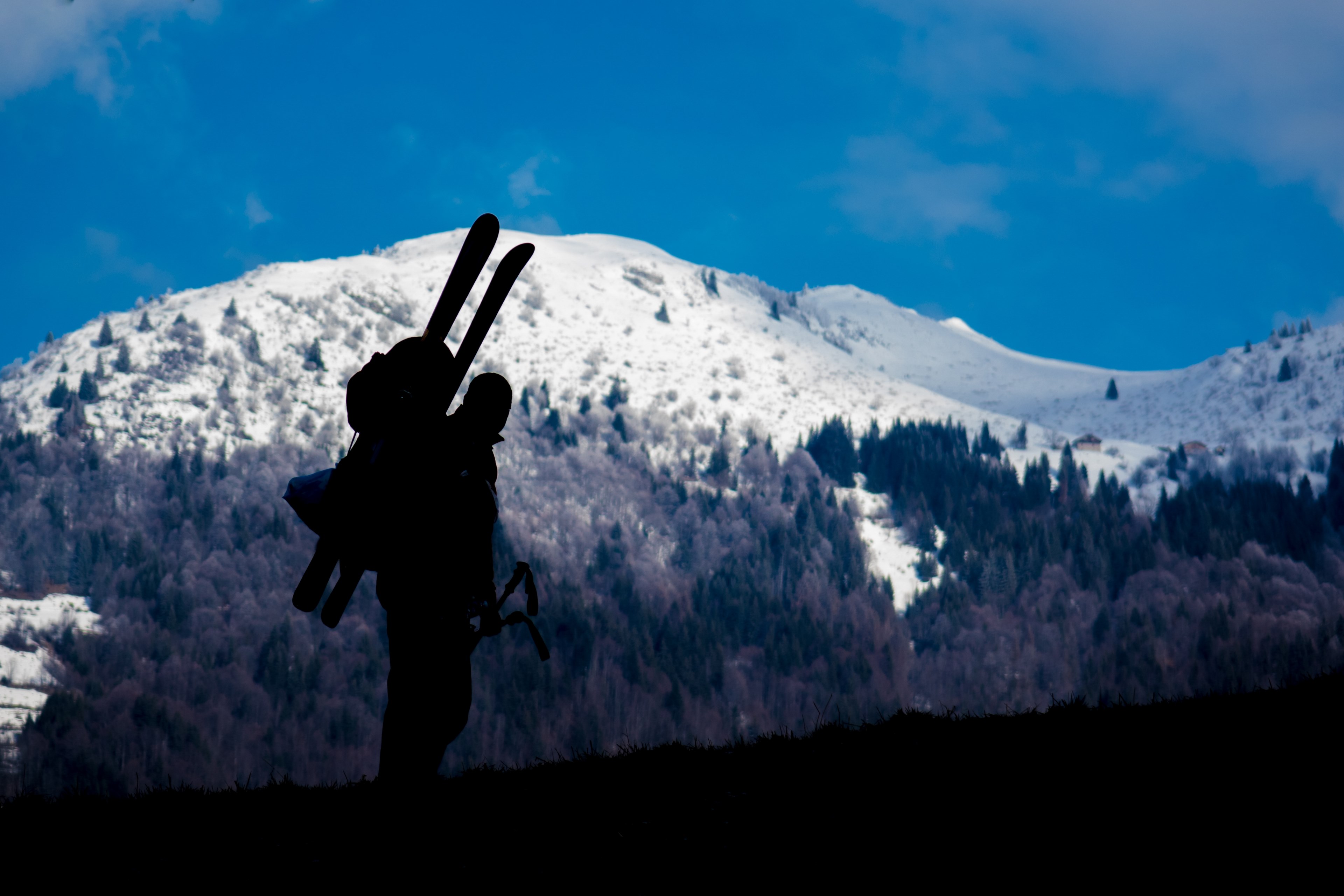 silhouette of a skier ascending a snowy blue mountain landscape, skiers silhouette 4k, HD Wallpaper