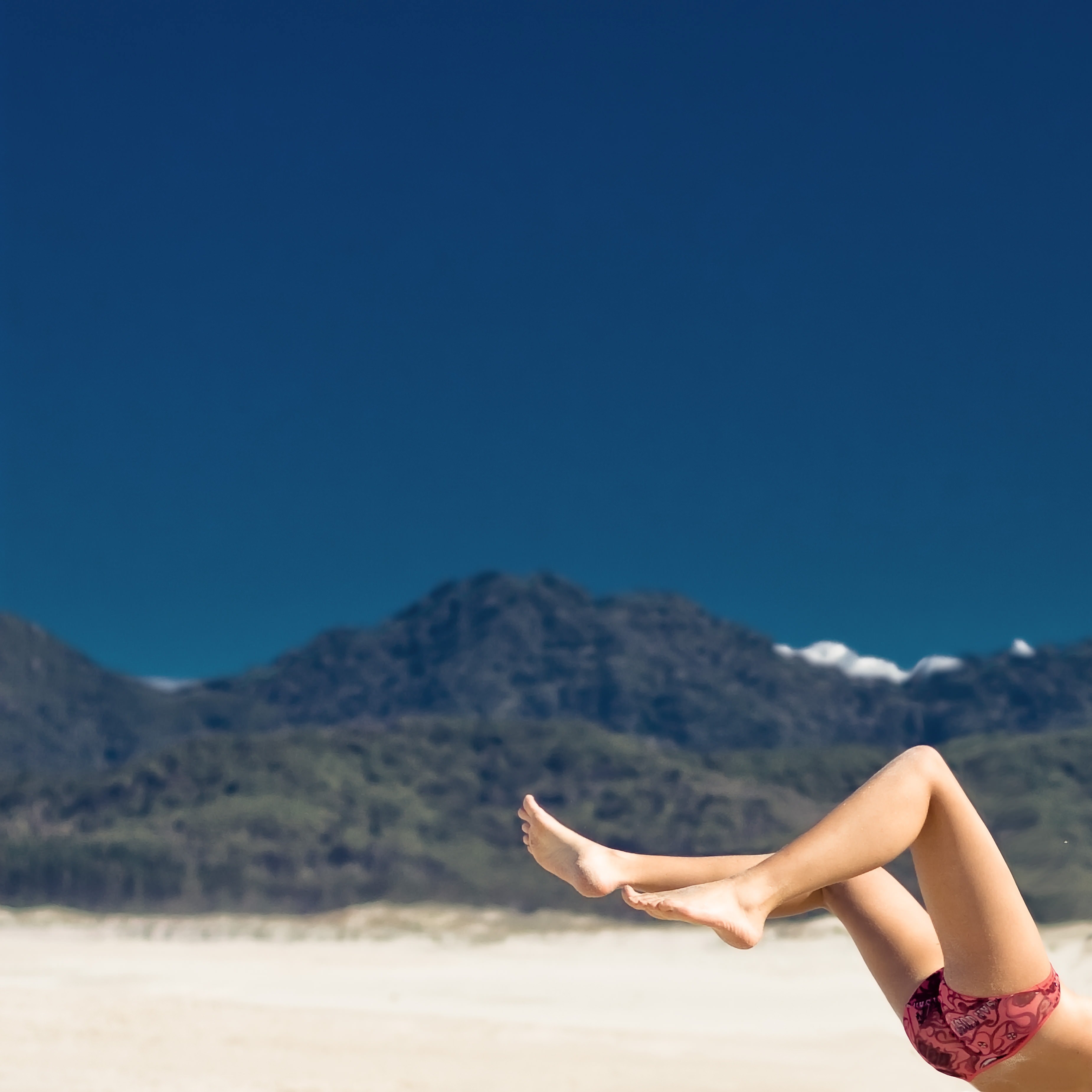 womans leg features in landscape view of a huge distant mountain in summer great barrier island, summer at great barrier island 4k, HD Wallpaper
