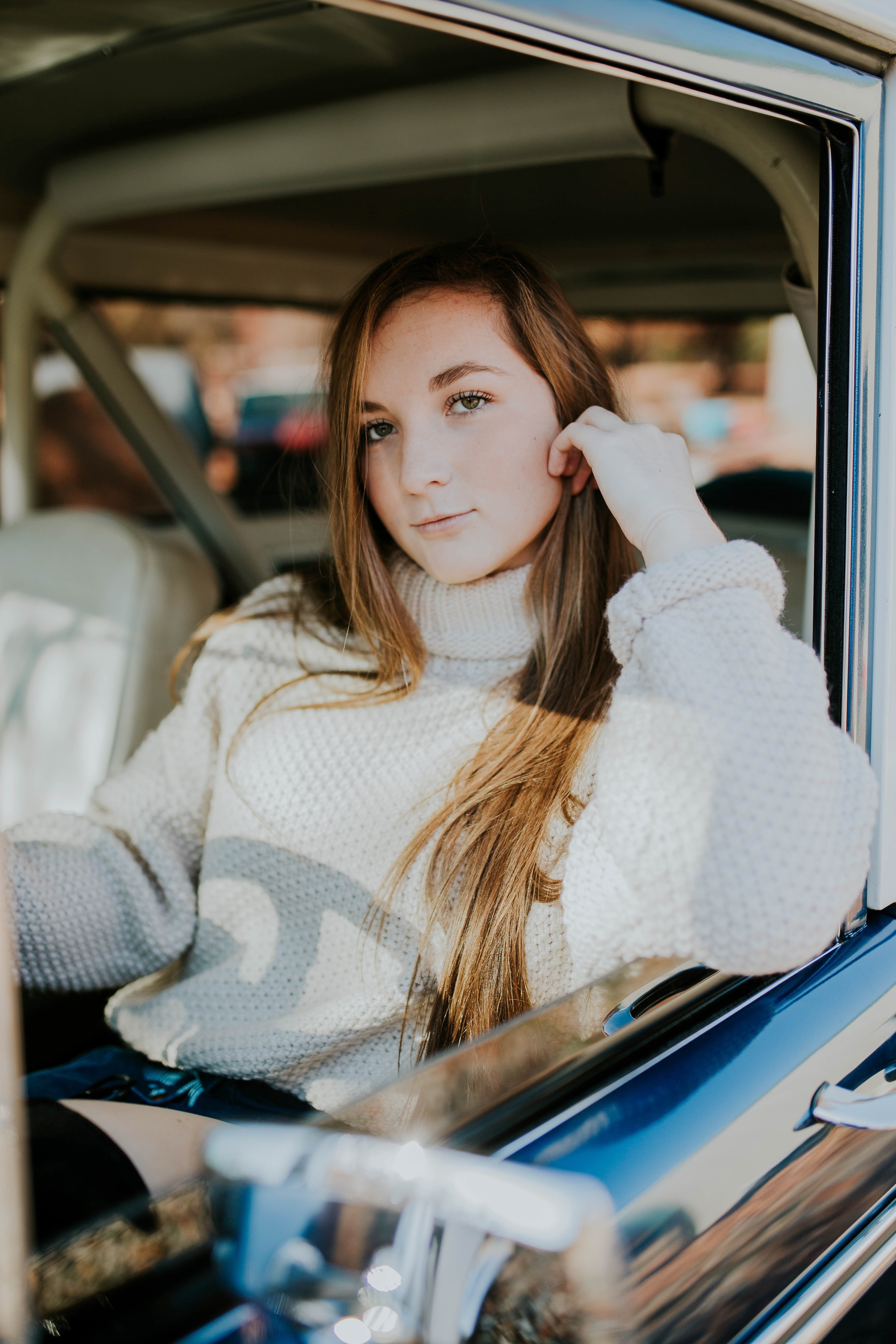 woman sitting in the drivers seat of a vintage car, woman knitwear car 4k, Phone HD Wallpaper