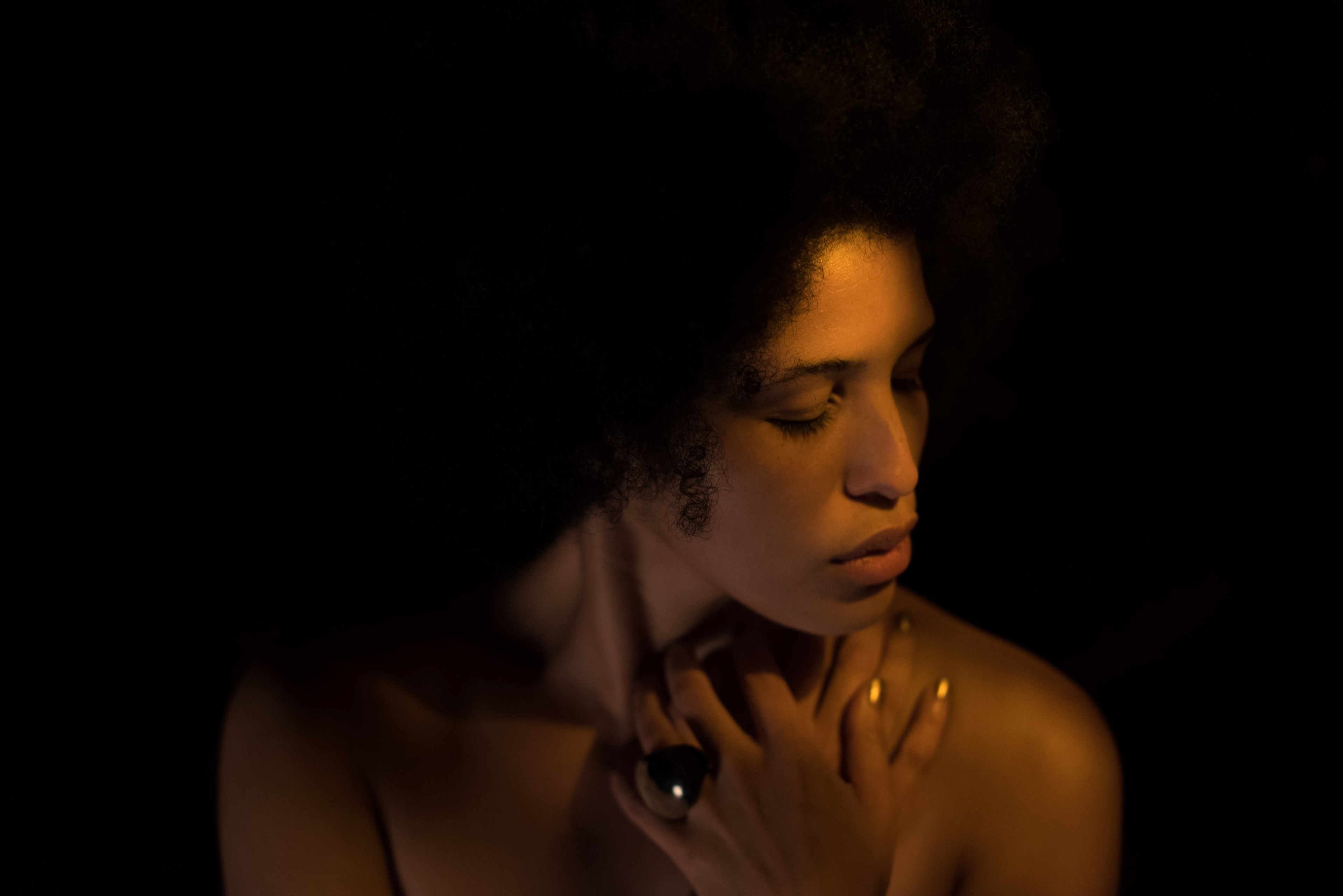 woman wearing ring with curly hair poses in dark lighting with eyes closed a, a broken heart_ 4k, HD Wallpaper