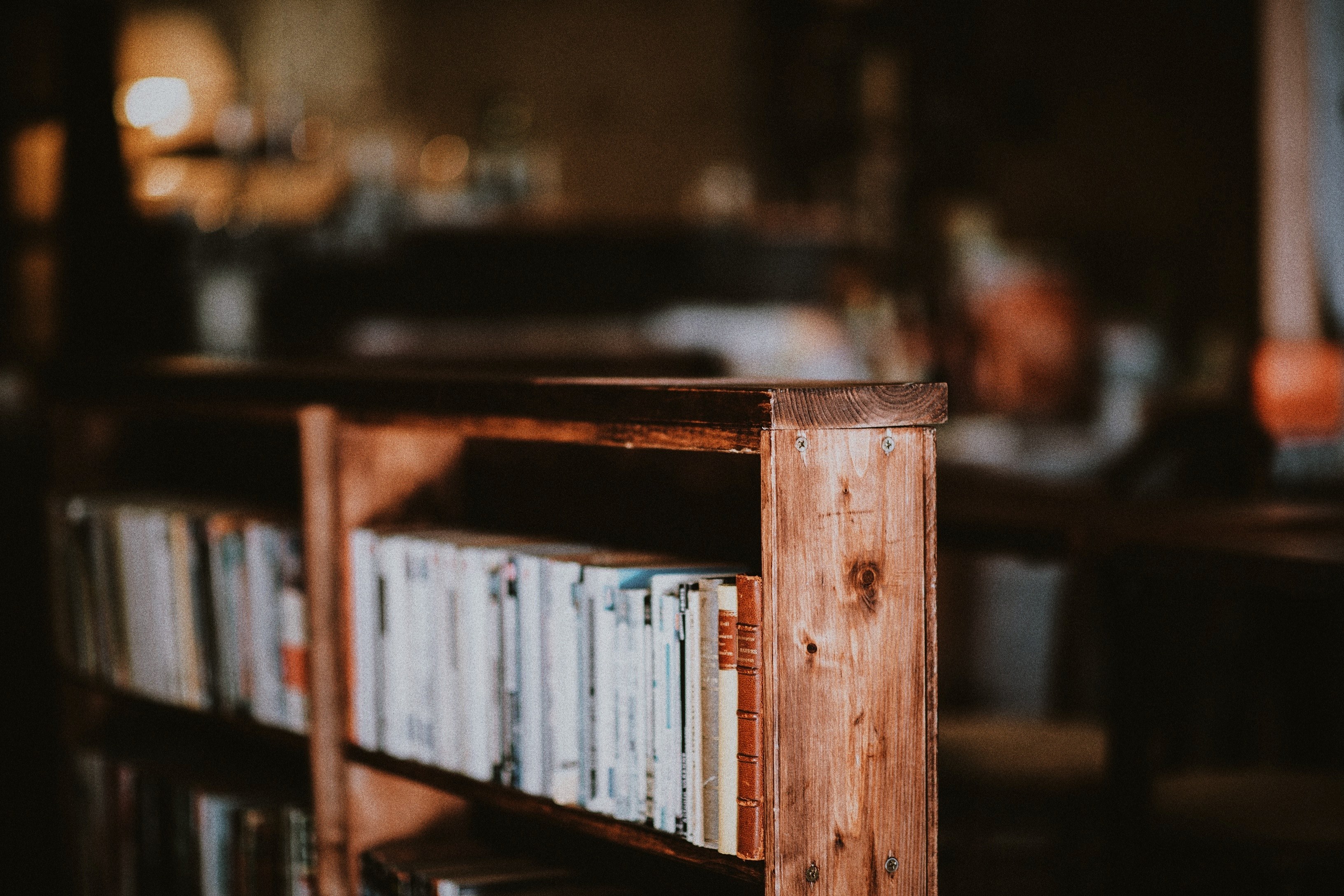 a bookcase with shelves full of old books, old books on a shelf 4k, HD Wallpaper