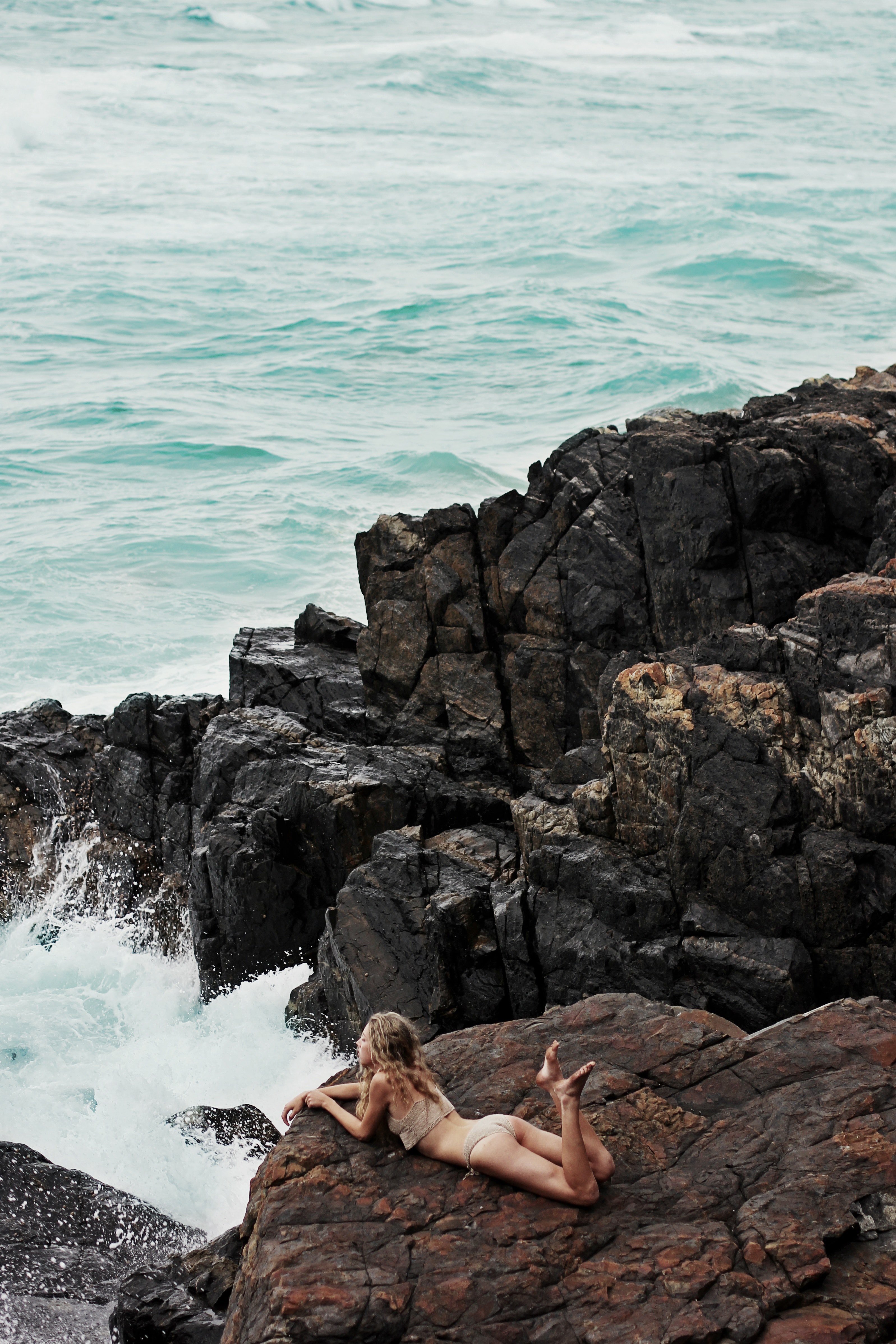 a woman lying on her stomach on the edge of a seaside cliff, _mermaid among the rocks 4k, Phone HD Wallpaper