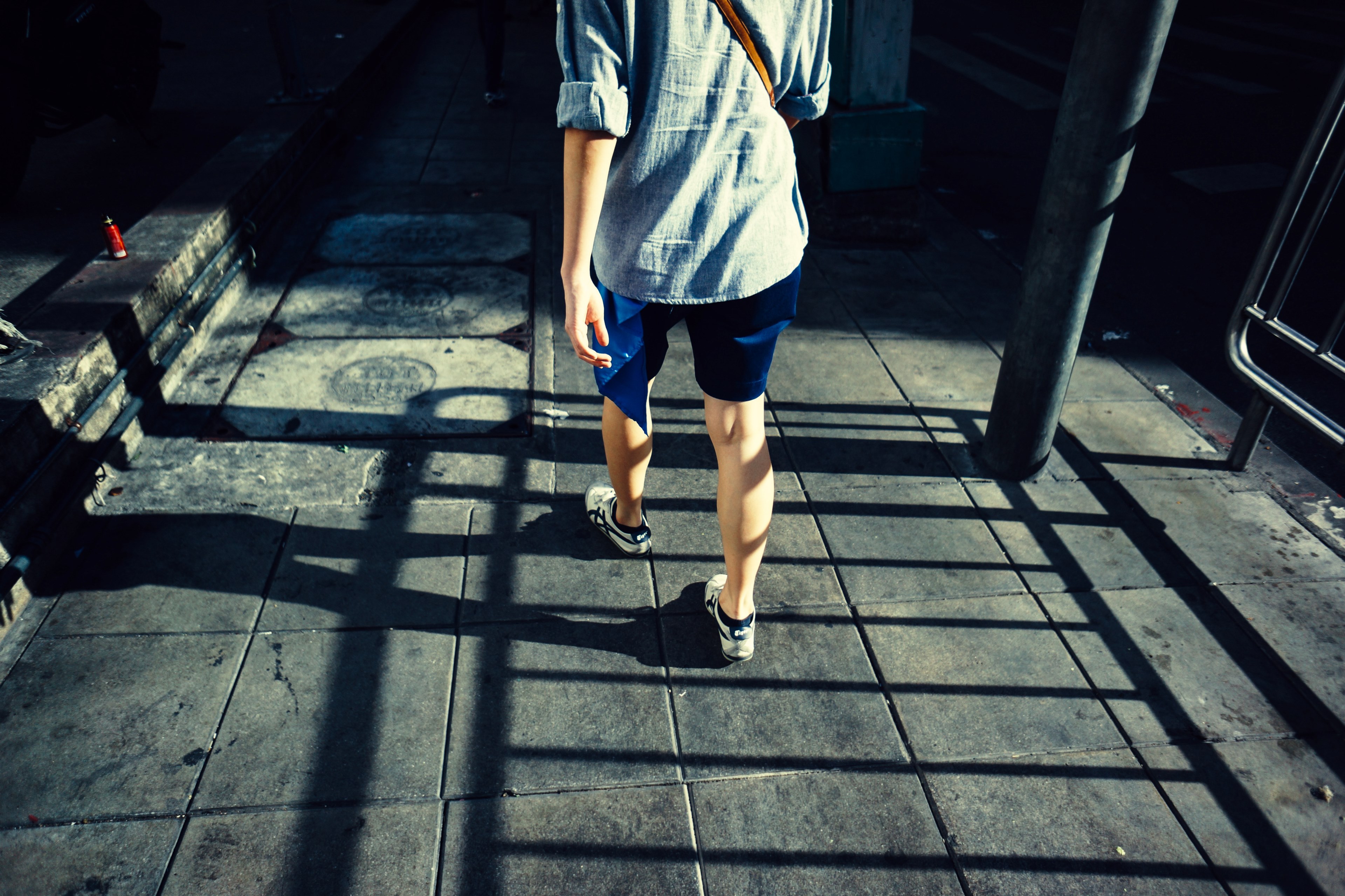 a person walking in sneakers shorts a long sleeve shirt and a shoulder bag in bangkok, but wherever i go ill be looking for you_ 4k, HD Wallpaper
