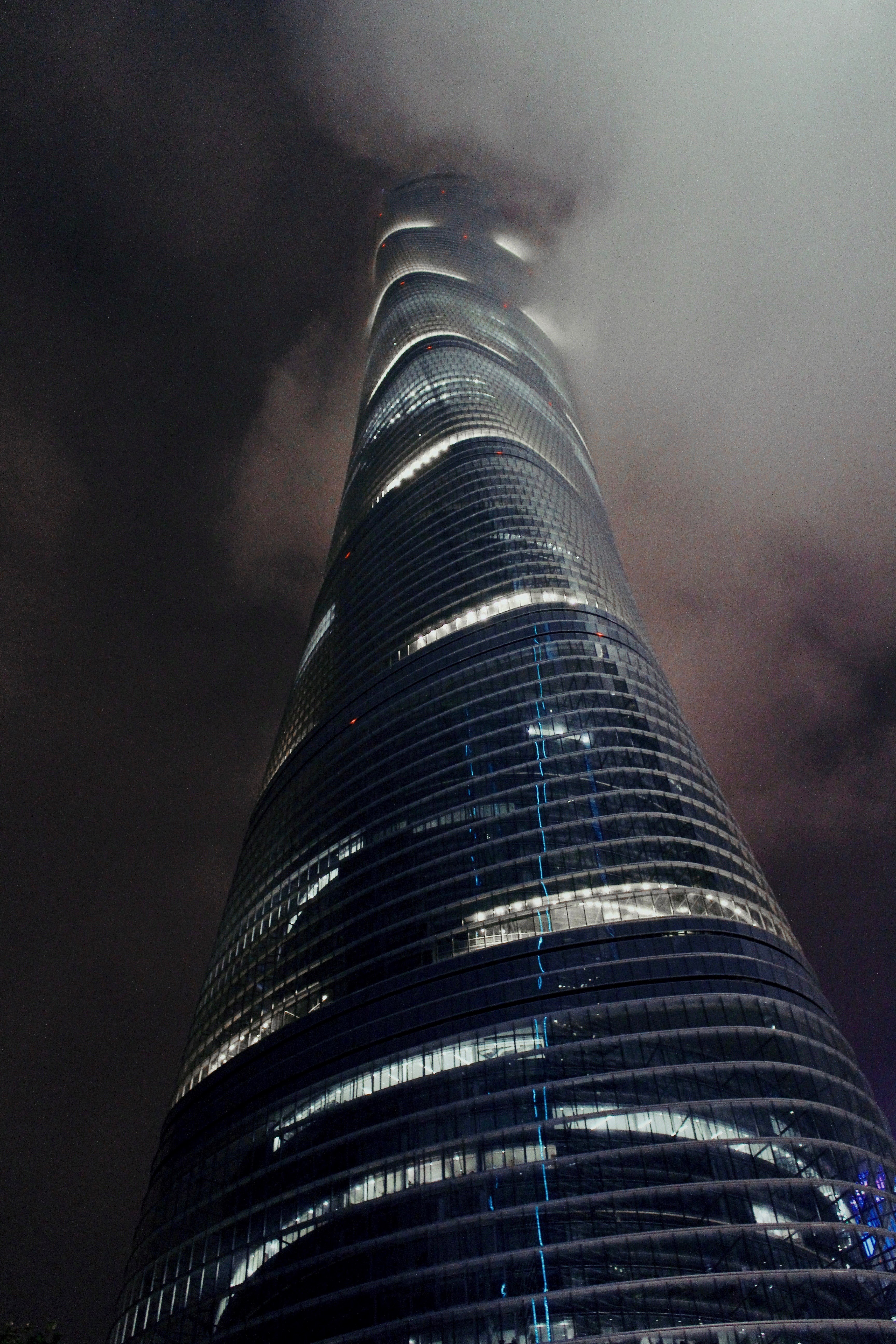 a tall twisting skyscraper in thick fog on an evening, shanghai tower 4k, Phone HD Wallpaper