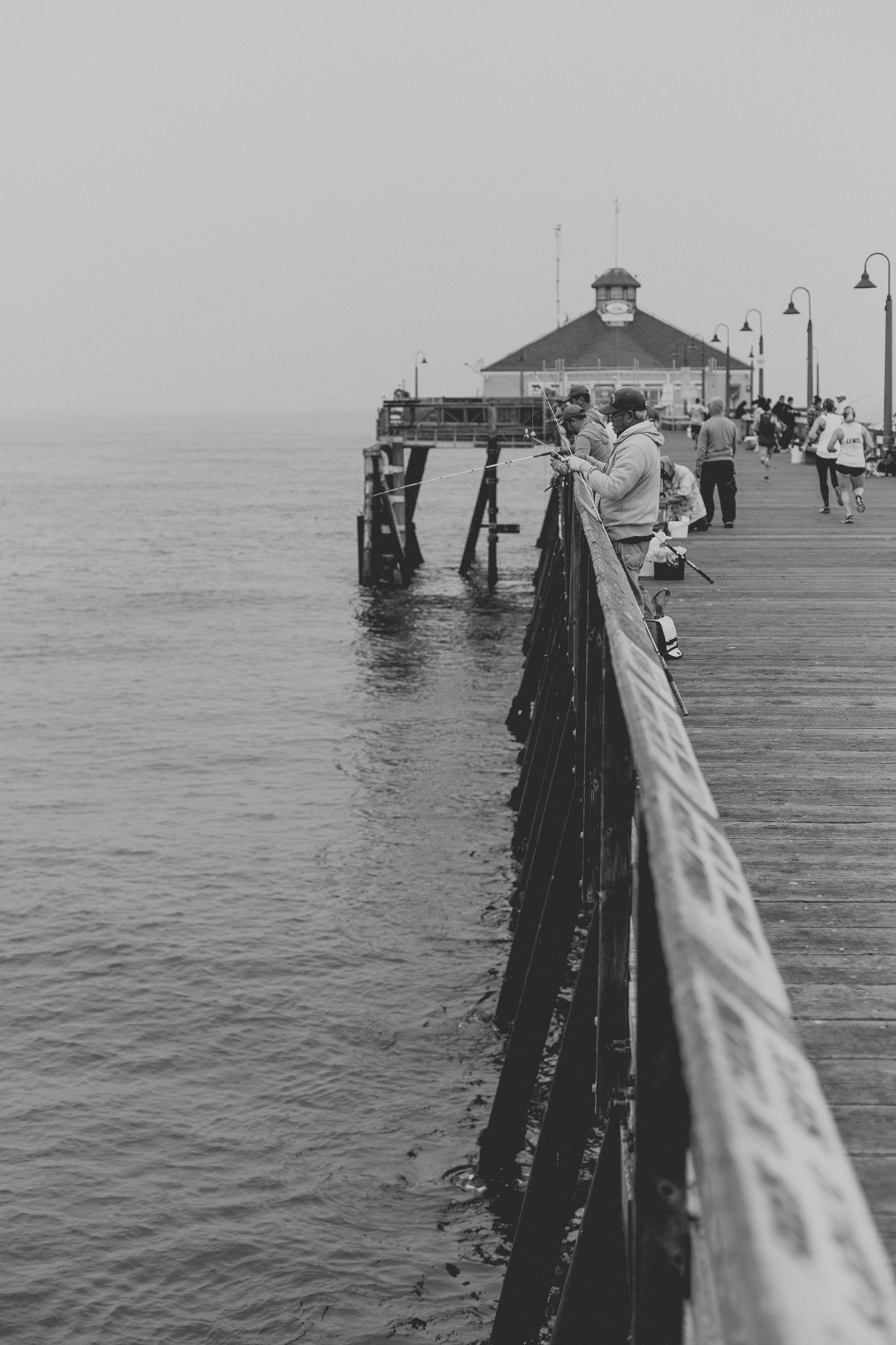 black and white photograph of people fishing on a pier at imperial beach, people fishing on a pier 4k, Phone HD Wallpaper