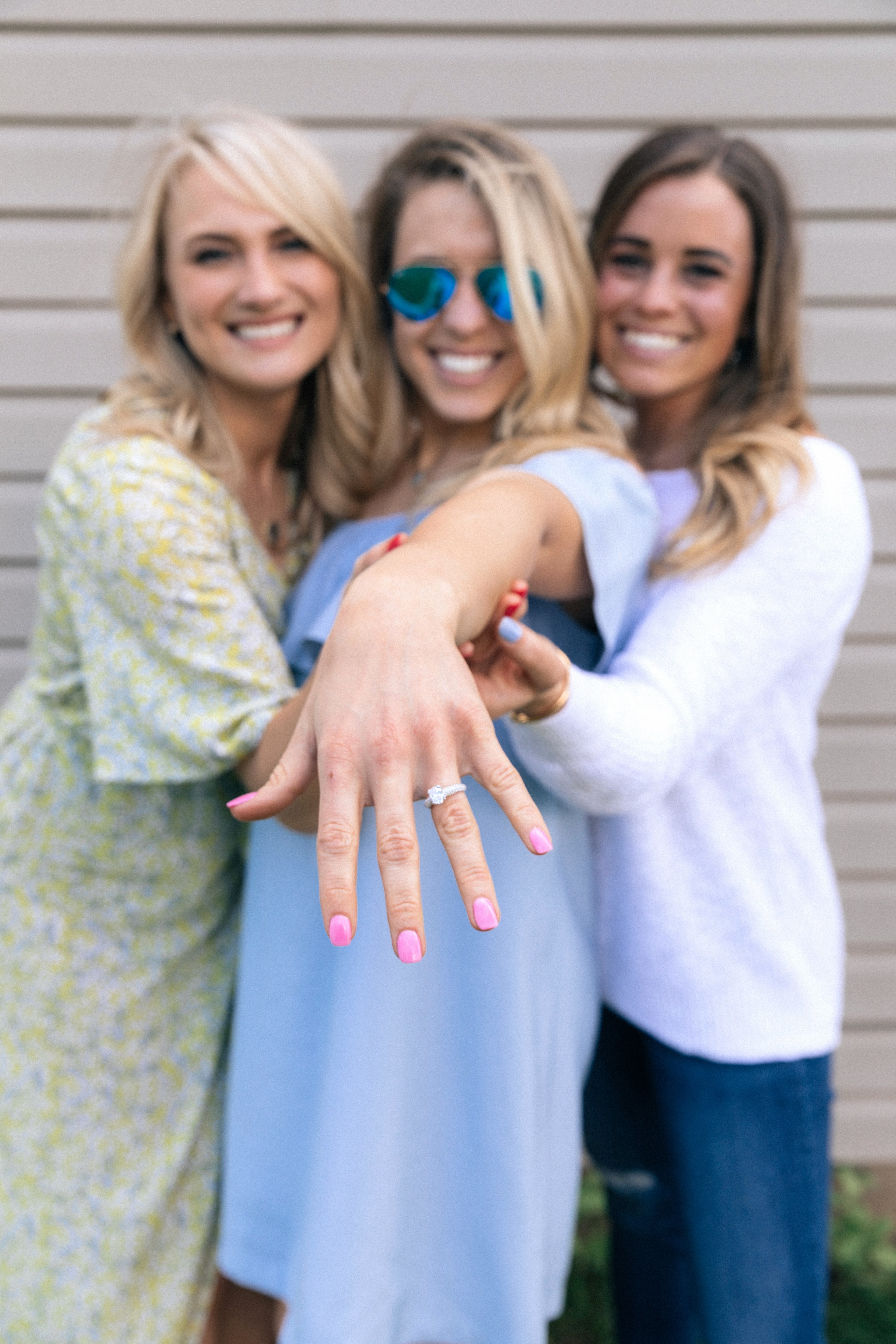 three women stand together holding up one of their arms to display her engagement ring, friends show off engagement ring 4k, Phone HD Wallpaper