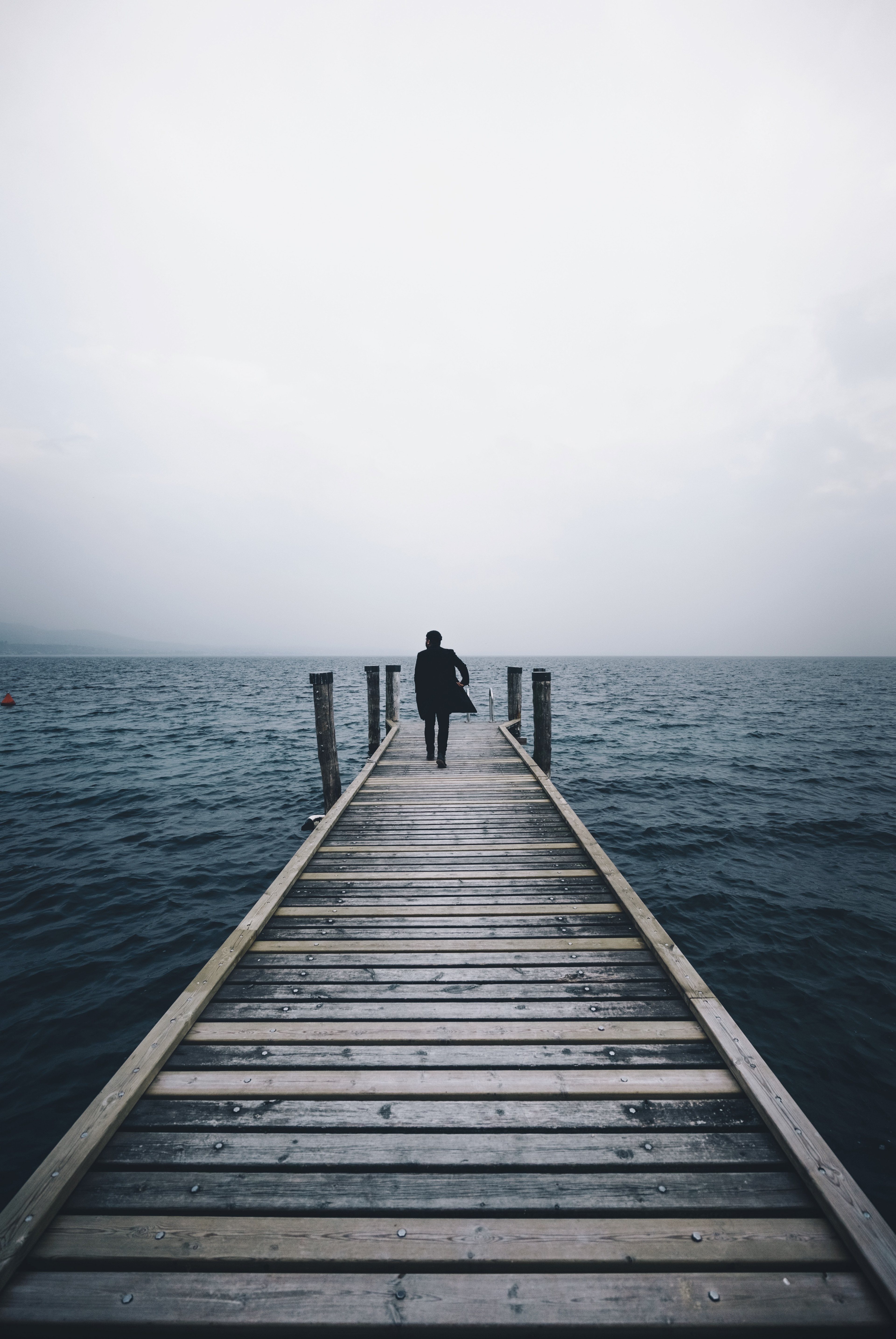 person walks on pier on a misty morning near the ocean, walking towards the water 4k, Phone HD Wallpaper