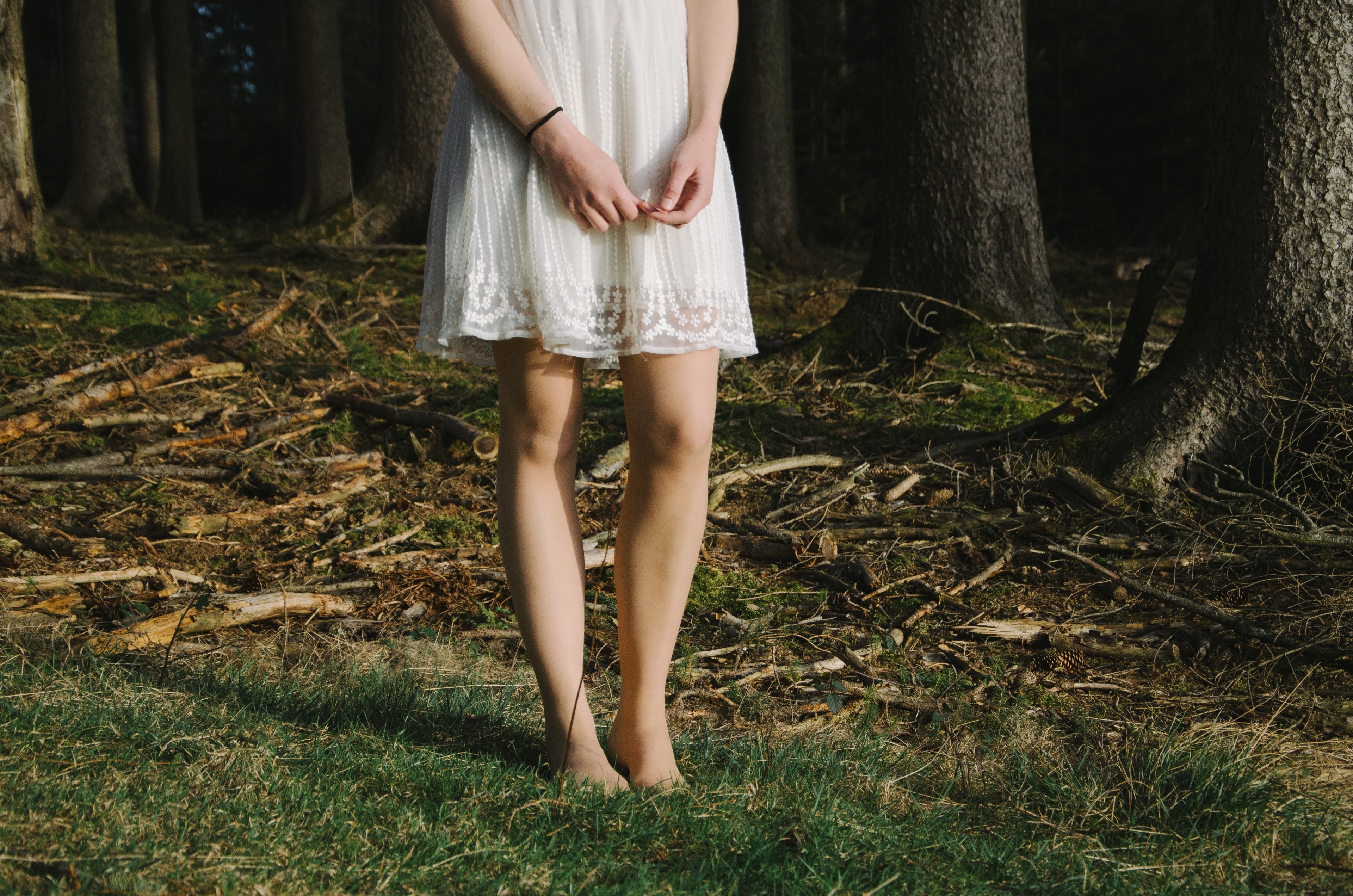 a woman in a lace dress standing barefoot on grass near a forest, woman in a dress by a forest 4k, HD Wallpaper