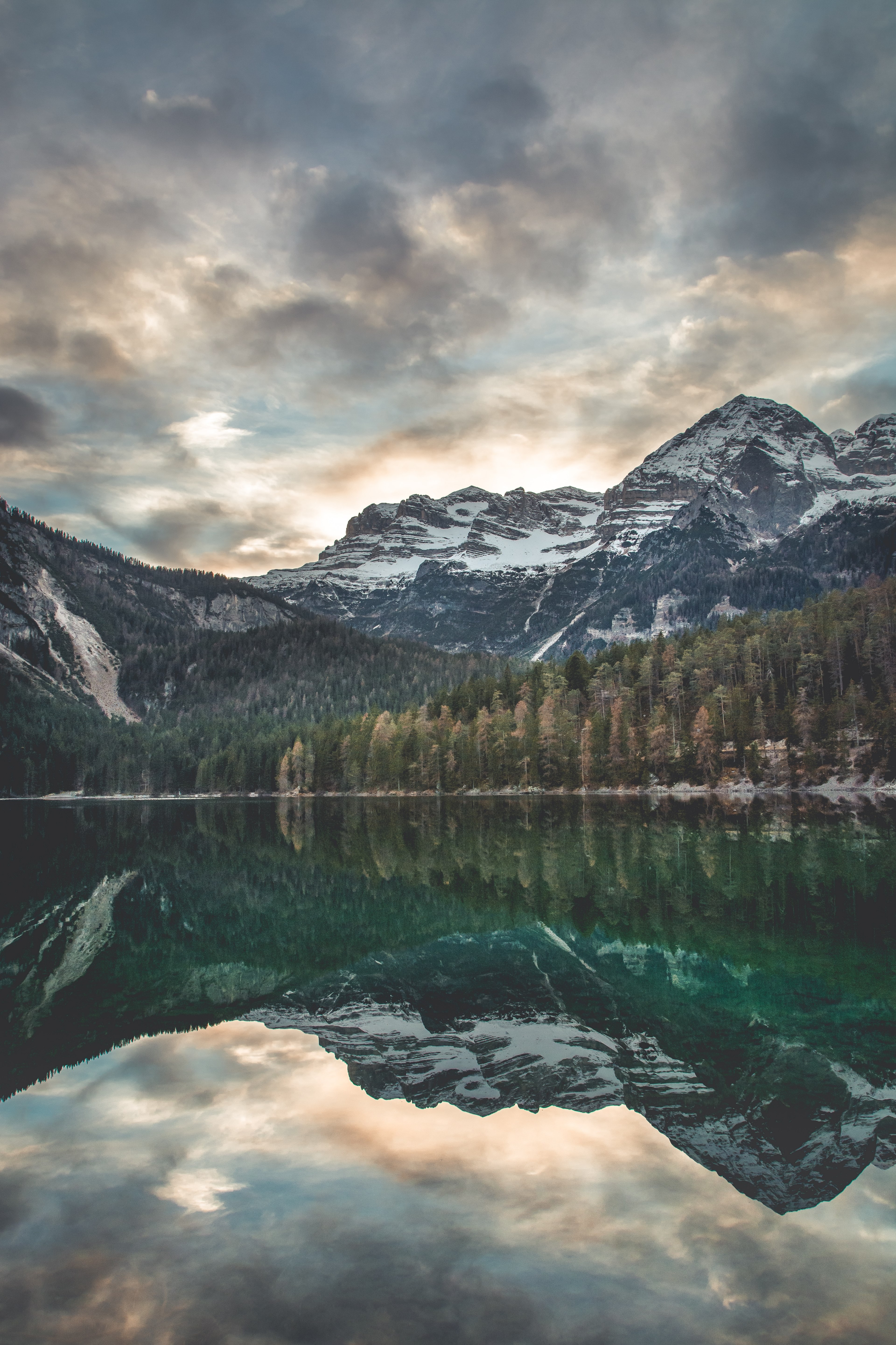a scenic view of snowy mountains reflected in the surface of lake tovel, mountains by lake tovel 4k, Phone HD Wallpaper