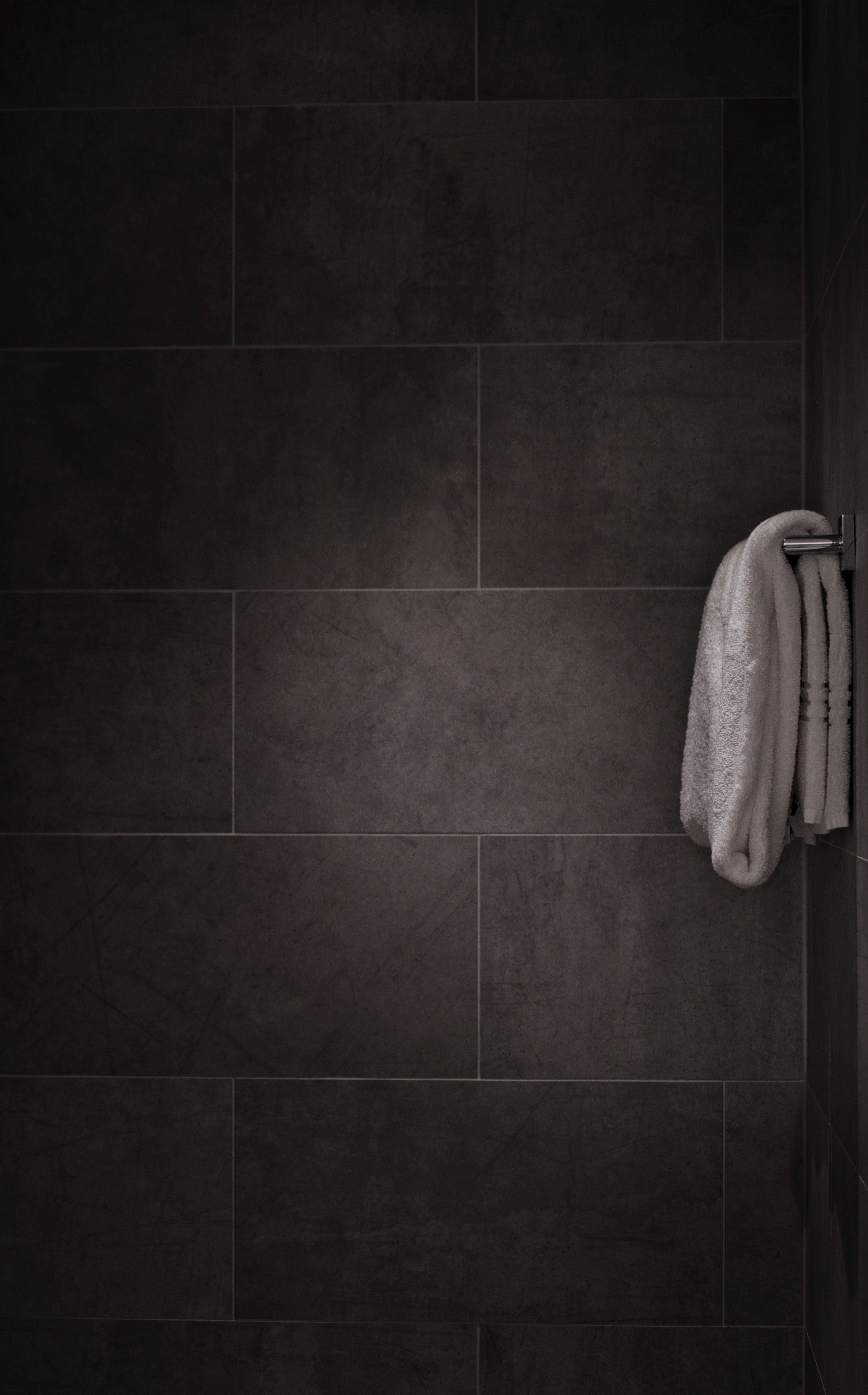 black and white minimalist shot of white towel on rail in tiled bathroom, white towel in tiled bathroom 4k, Phone HD Wallpaper