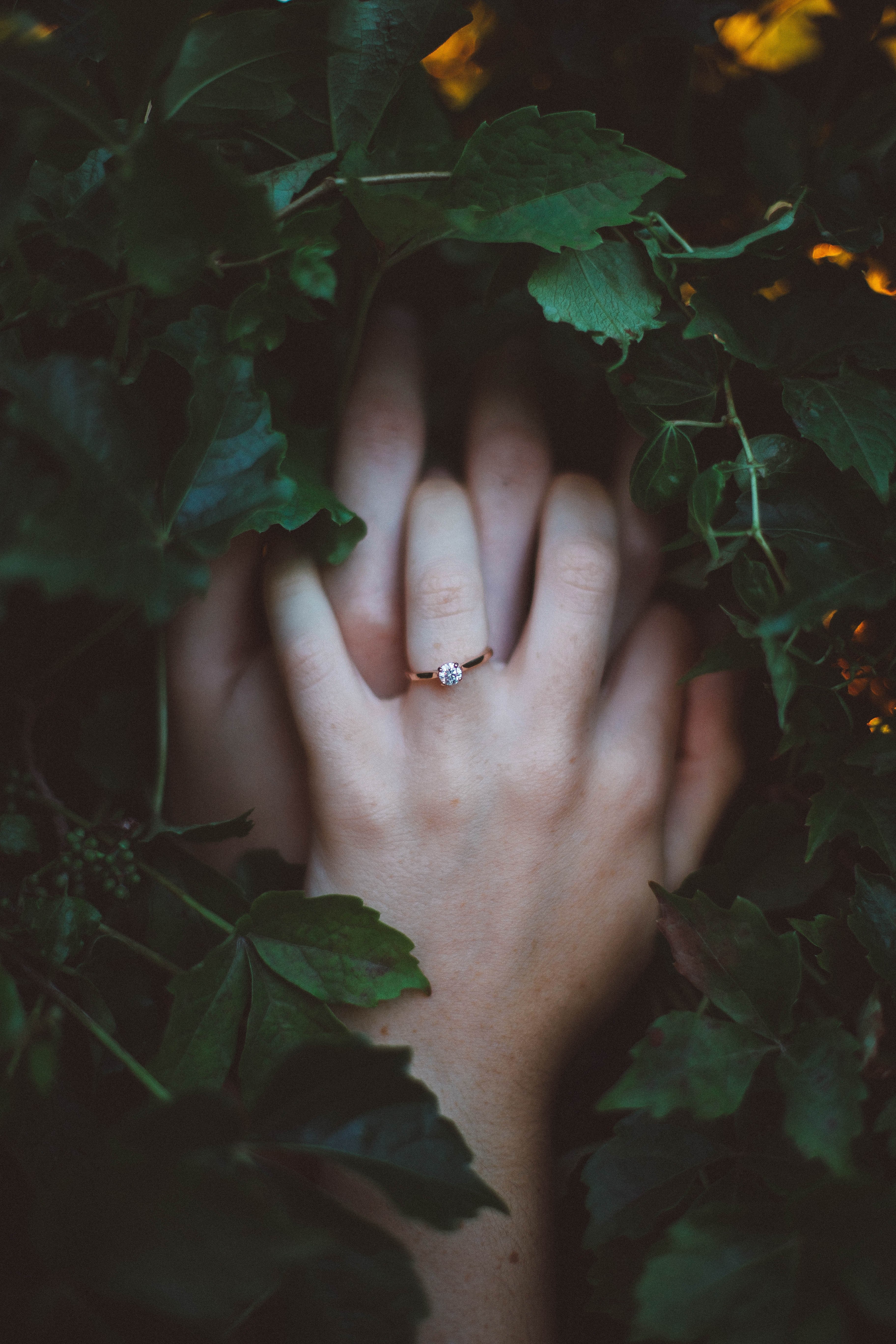 a ring is highlighted on a young womans hand clasped over her face behind vines, the day everything changed 4k, Phone HD Wallpaper