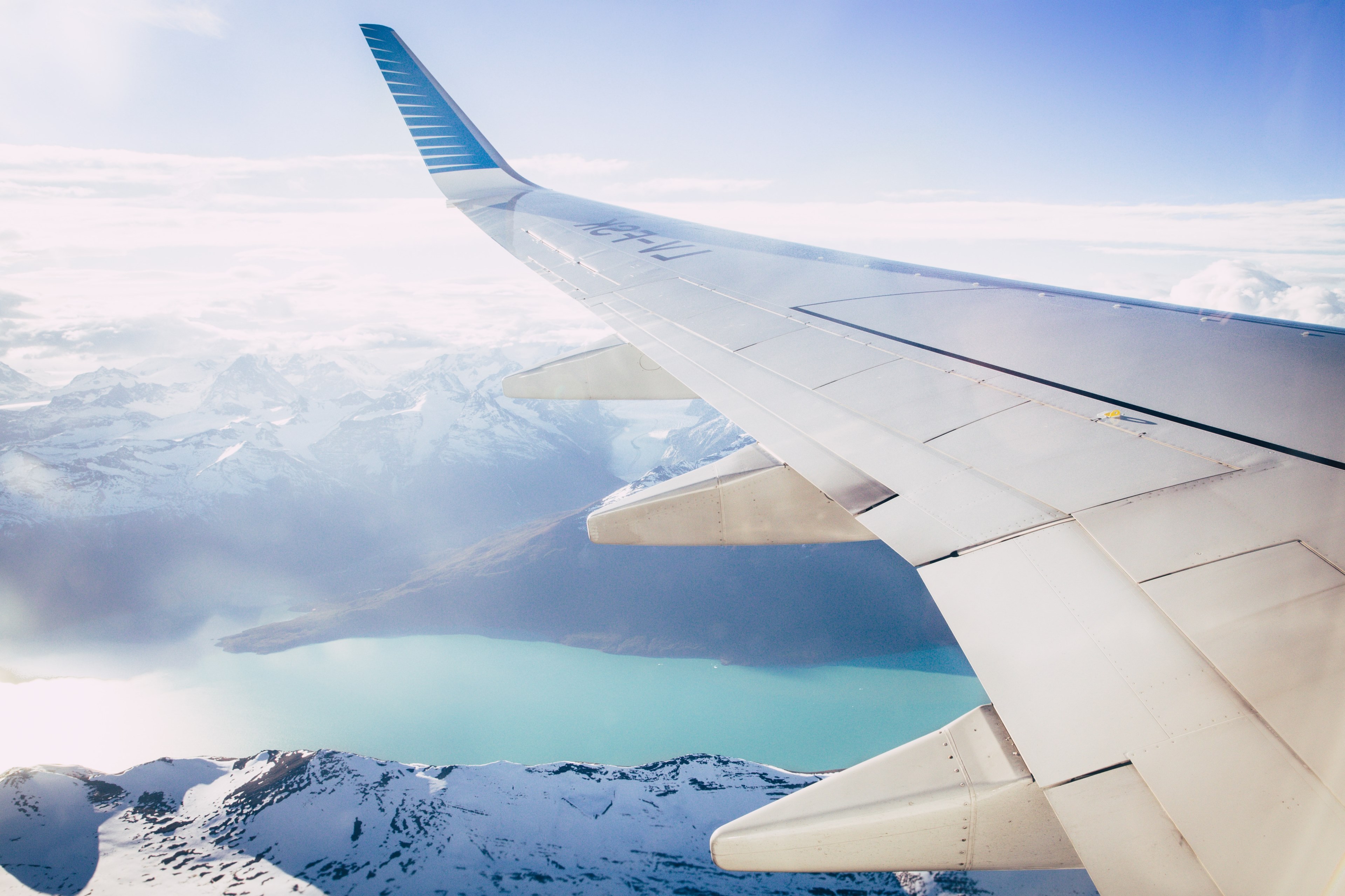 the view of the snowcapped mountains and blue river of perito moreno glacier from a window seat on an airplane, patagonia view 4k, HD Wallpaper