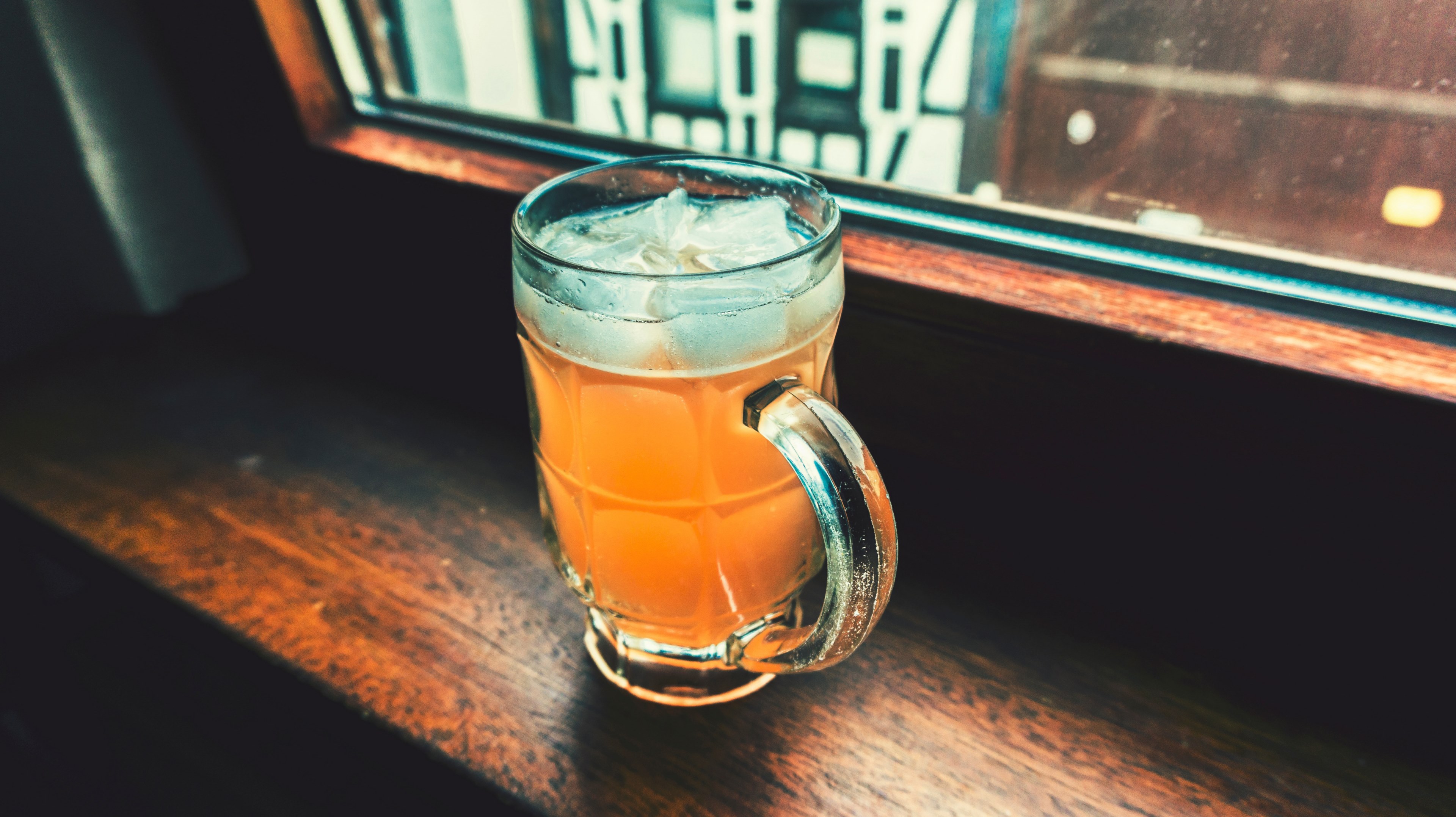 a glass cup with handle filled with drink and ice by a window, drink in the evening 4k, HD Wallpaper