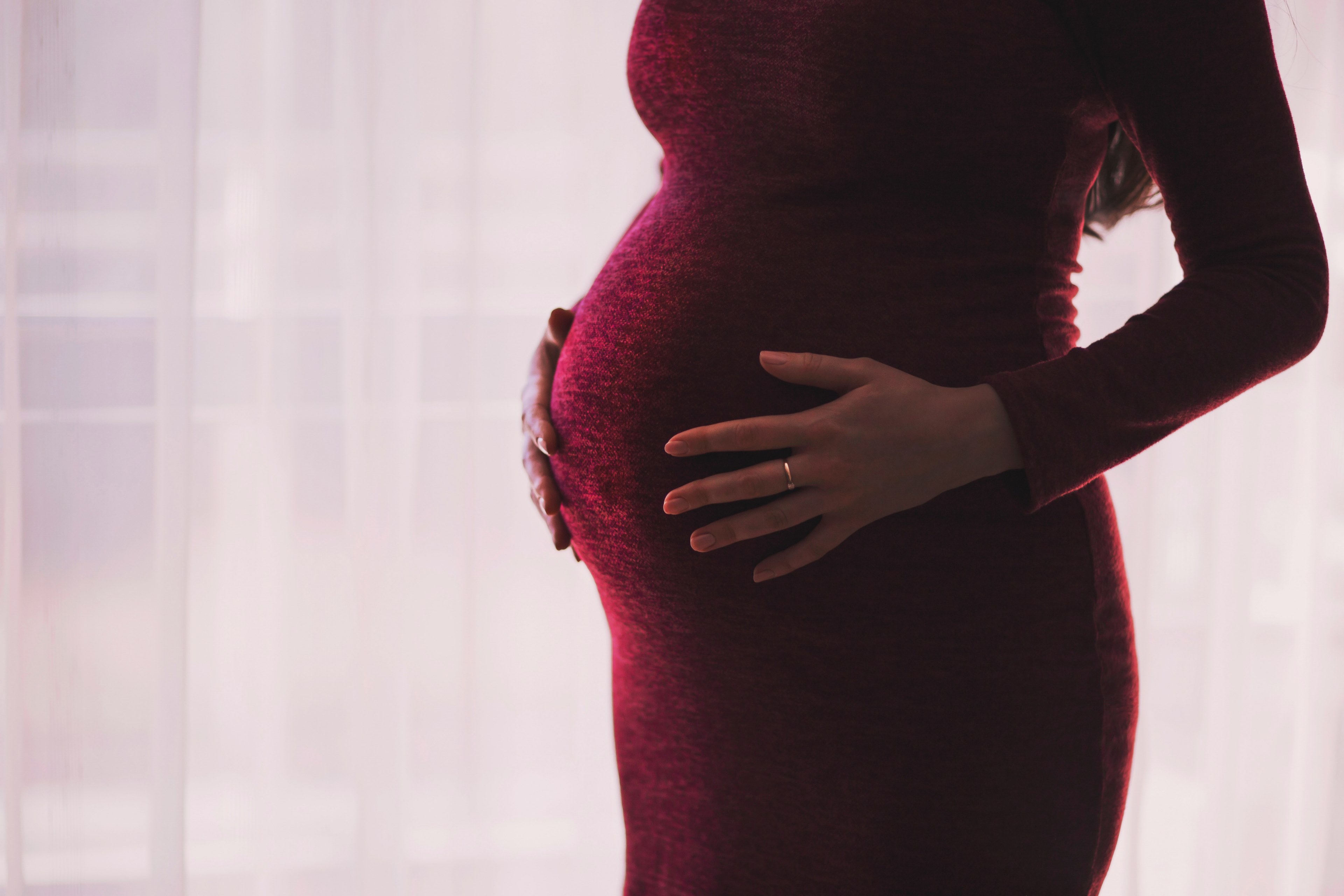 pregnant woman in form fitting crimson dress holds belly, any day now 4k, HD Wallpaper