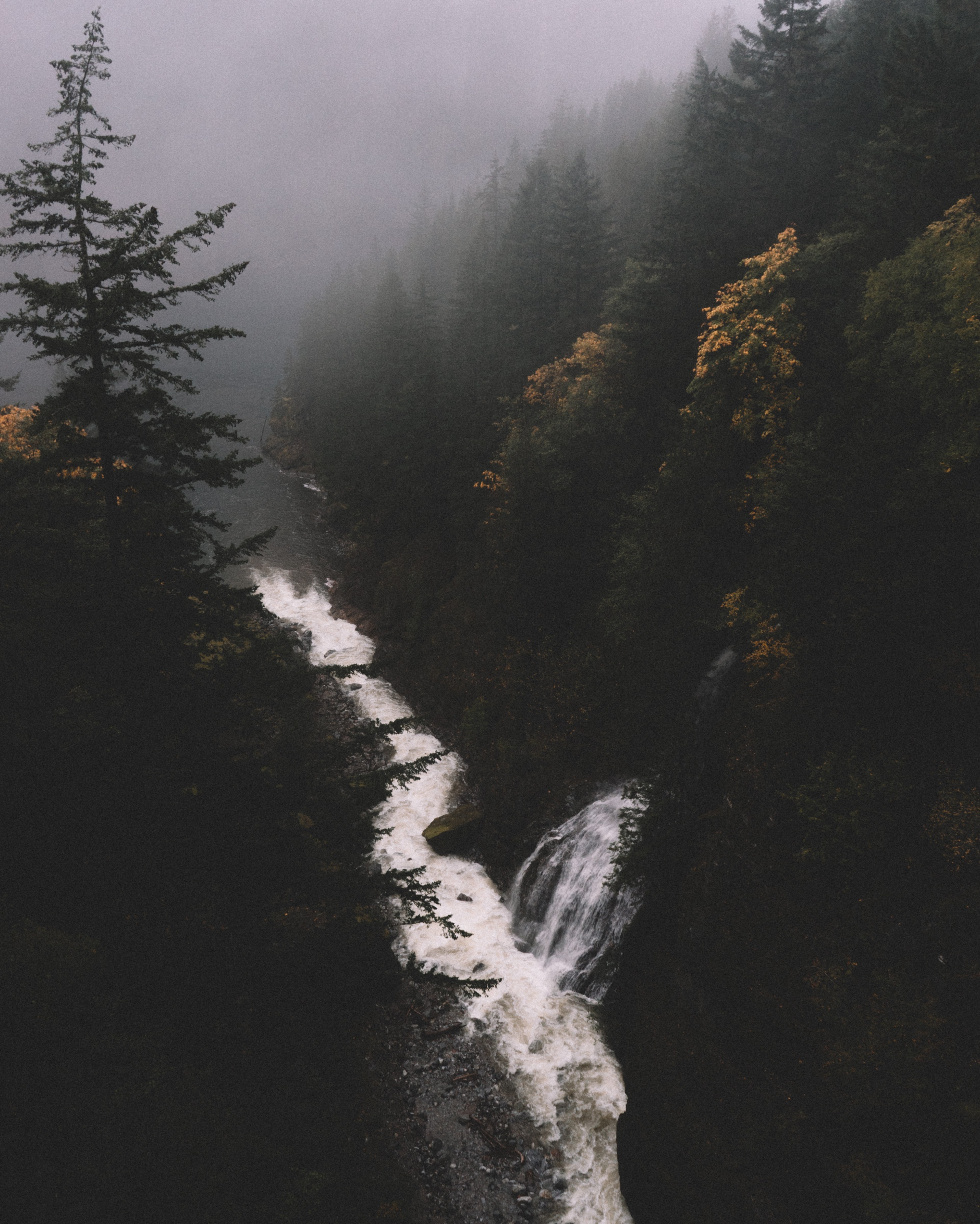a drone shot of a waterfall tumbling down into a stream in a forest, waterfall and creek in woods 4k, Phone HD Wallpaper