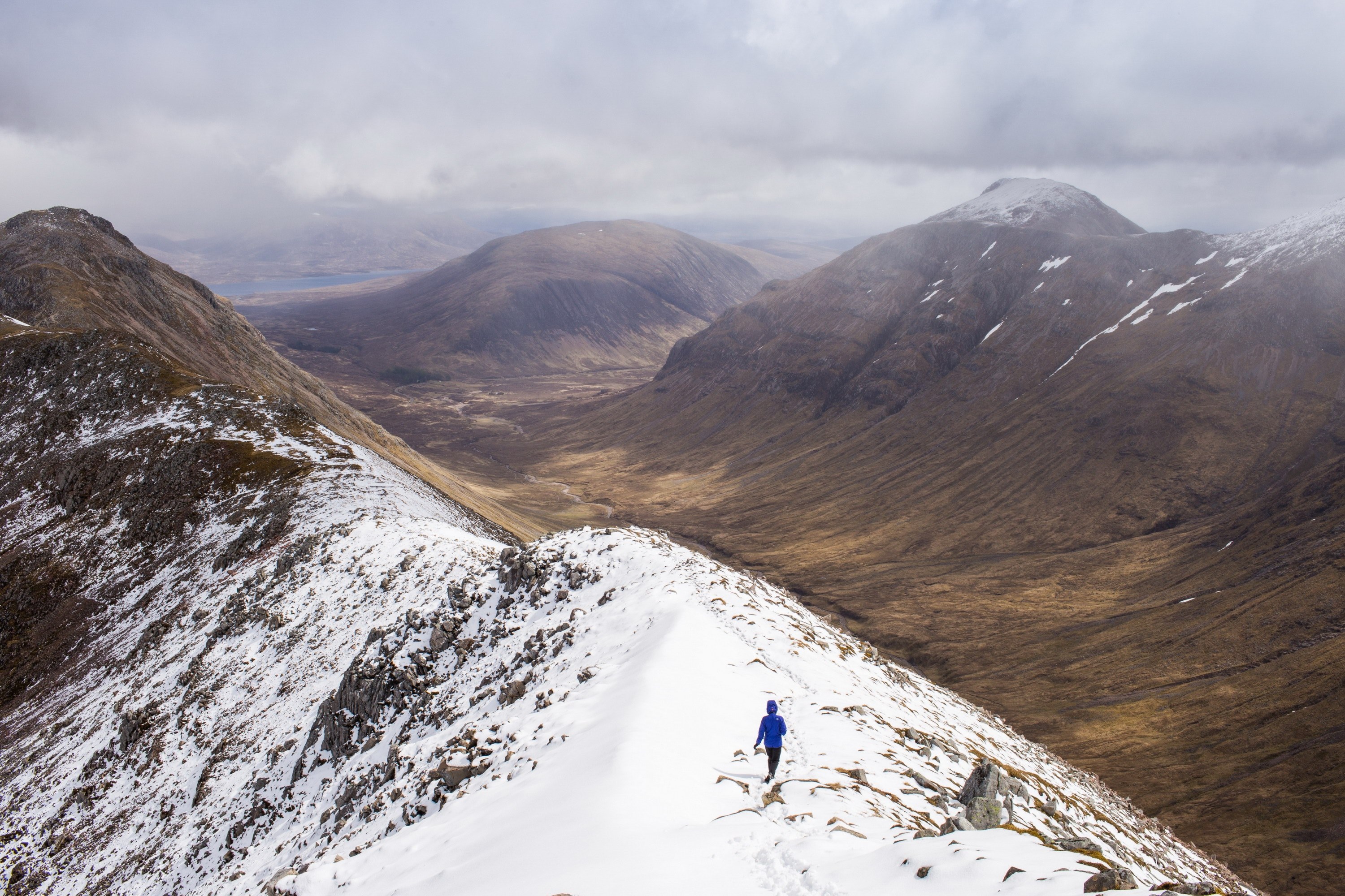 mountain range under clouds with hiker walking along the top in snow, hiking in the highlands near glencoe 4k, HD Wallpaper