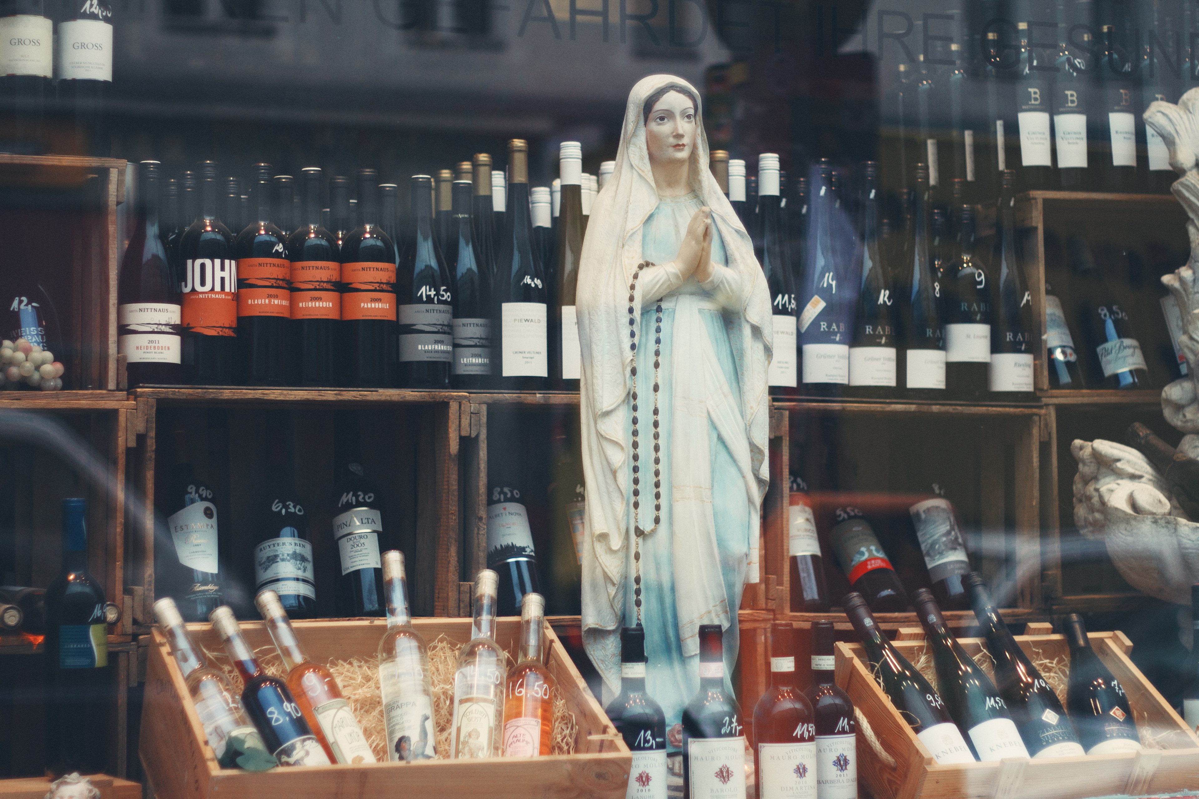 a statue of virgin mary with a rosary in a wine store, rosary and wine 4k, HD Wallpaper