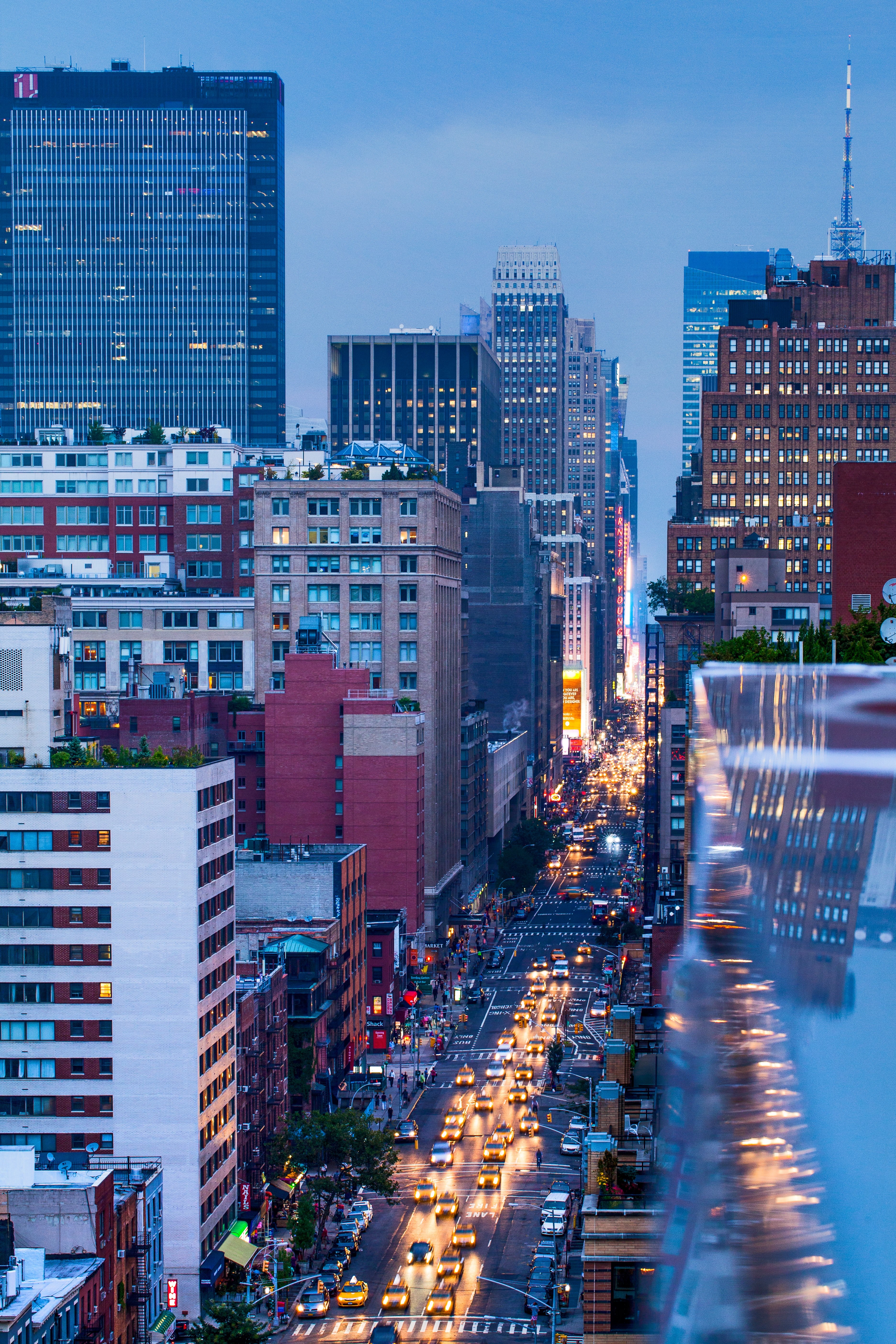 skyscrapers and busy road with yellow cabs and car headlights during night time 166 w 18th st, skyscrapers busy road night 4k, Phone HD Wallpaper