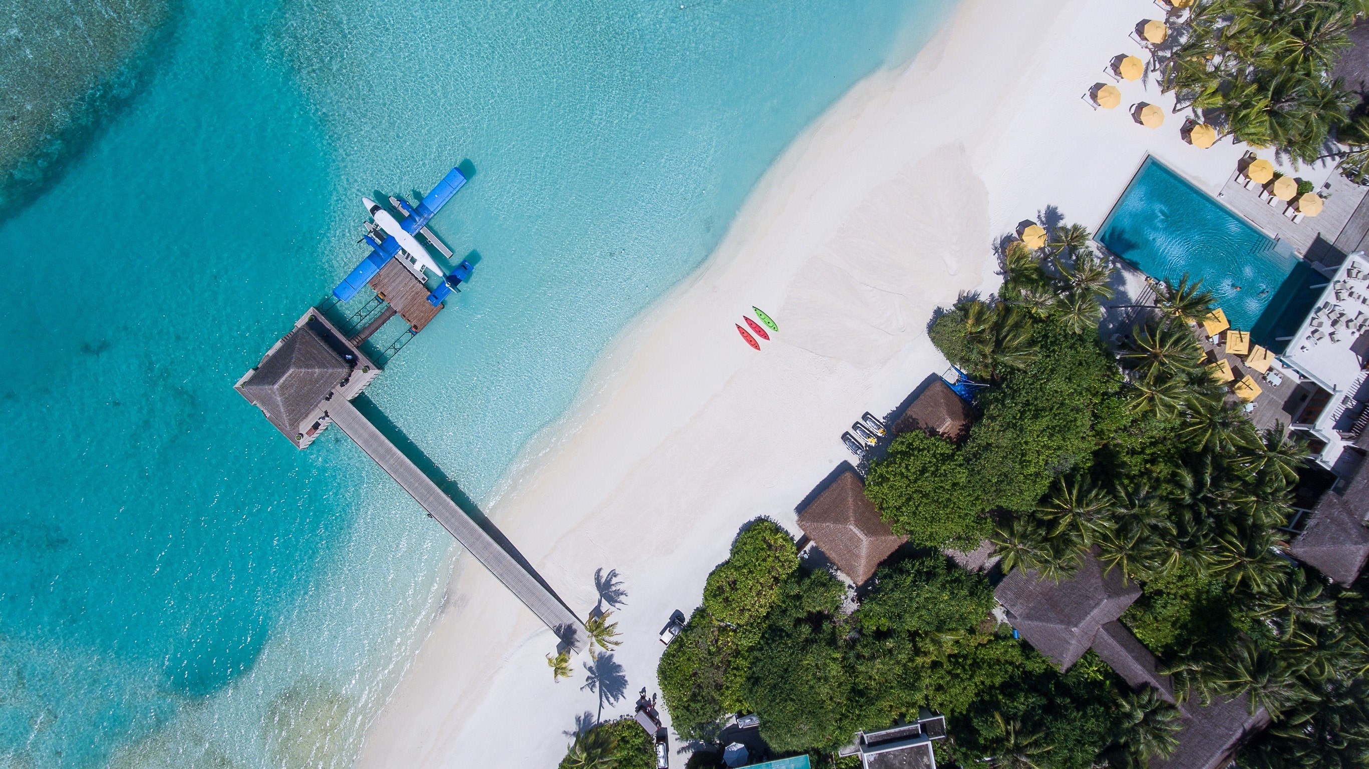 drone aerial view of an airplane docked at the pier on the sand beach in per aquum niyama, home 4k, HD Wallpaper