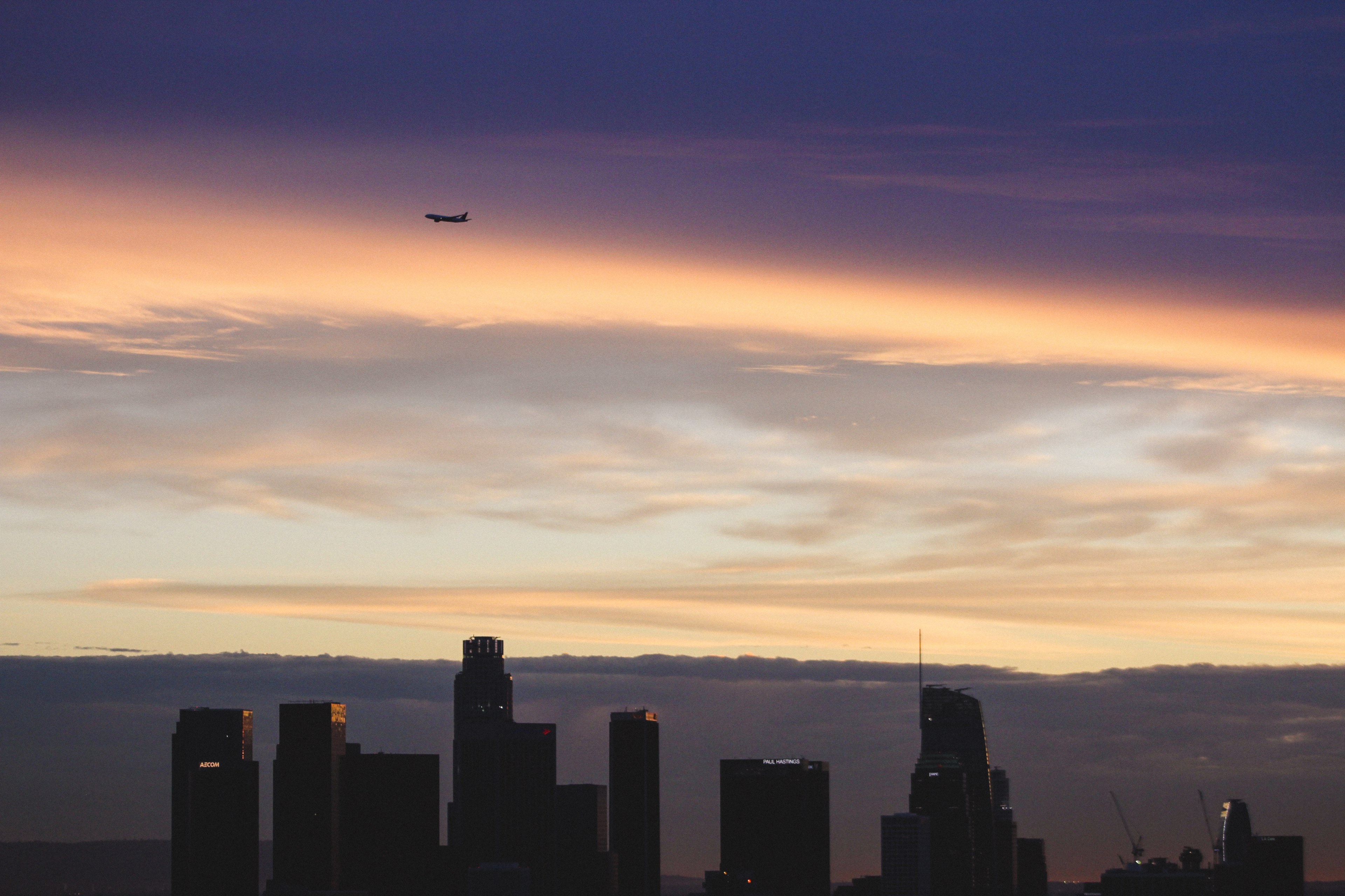 a plane flies over los angeles in front of a cloudy sunset, busy but subtle 4k, HD Wallpaper