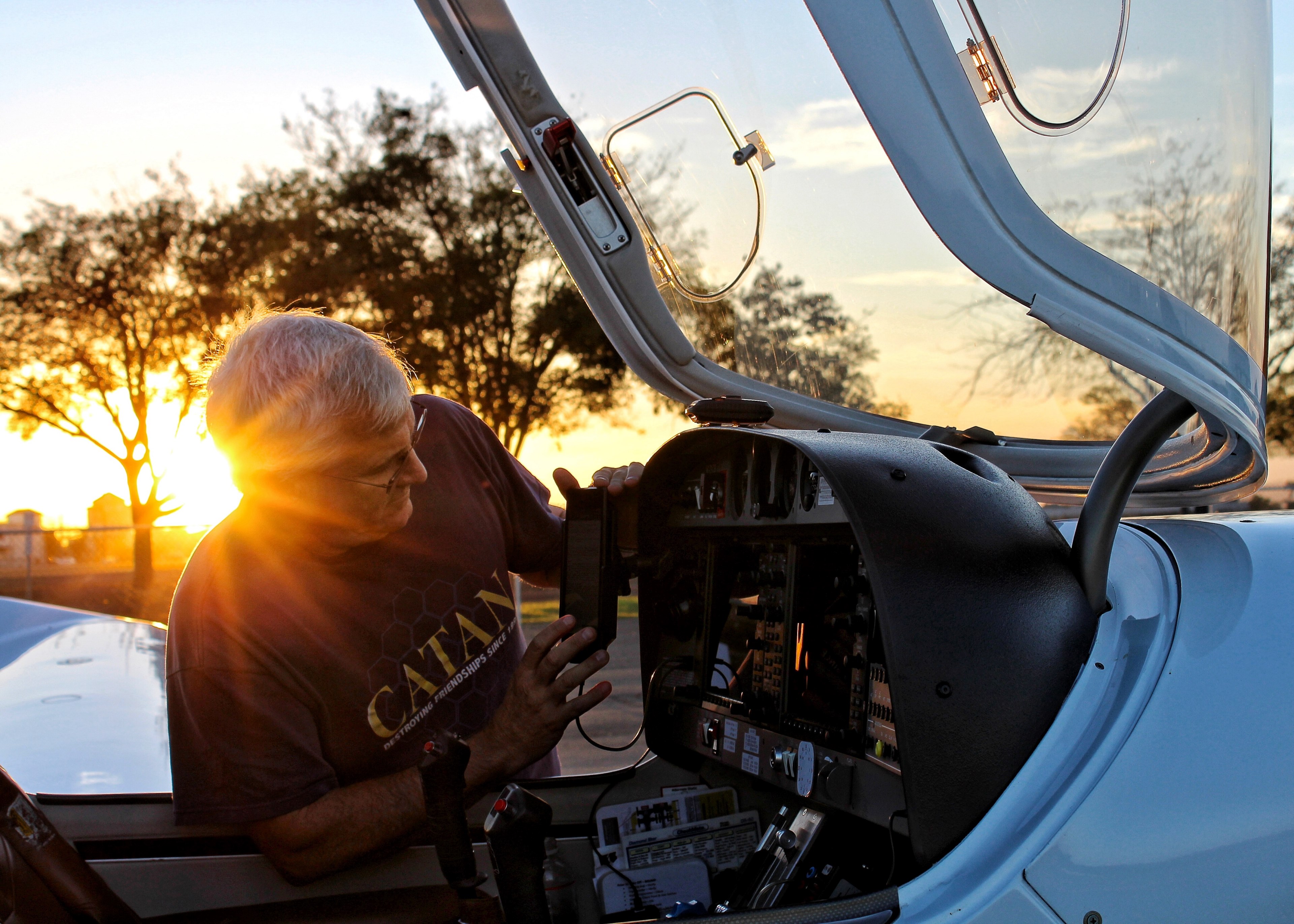 a man inspecting the equipment of a plane at los banos municipal airport during sunset, plane inspection at los banos municipal airport 4k, HD Wallpaper