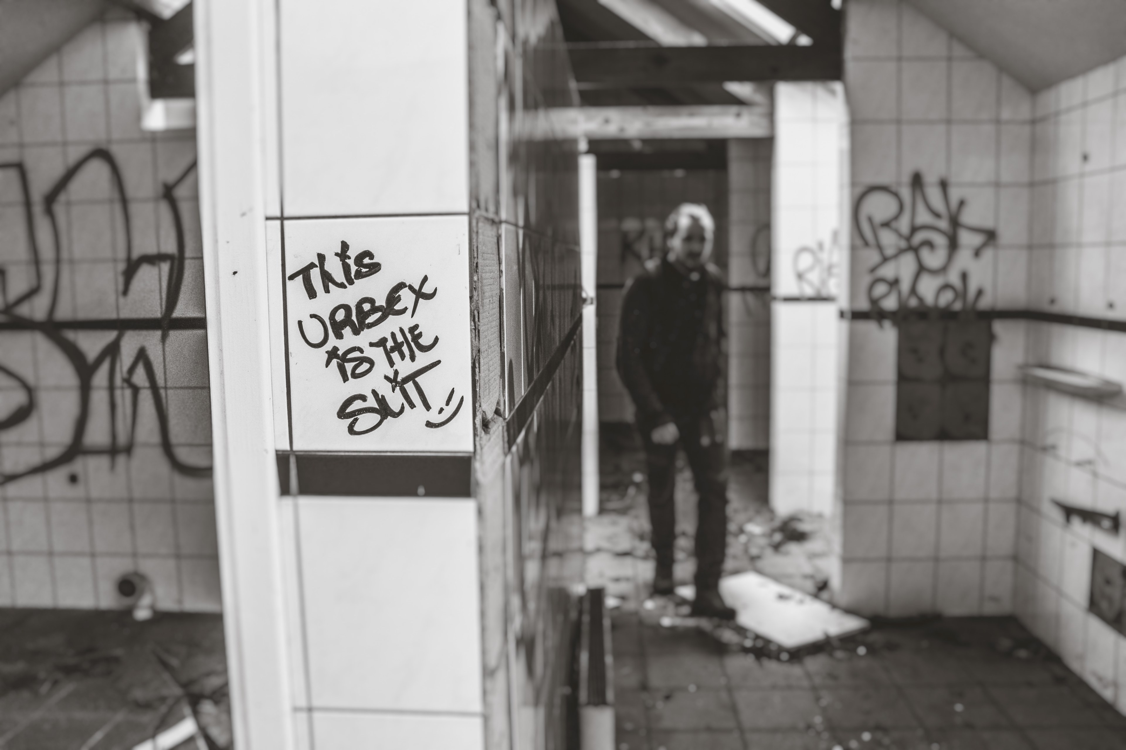 black and white shot of person in decaying bathroom with graffiti on walls in doel, doel belgium_ 4k, HD Wallpaper